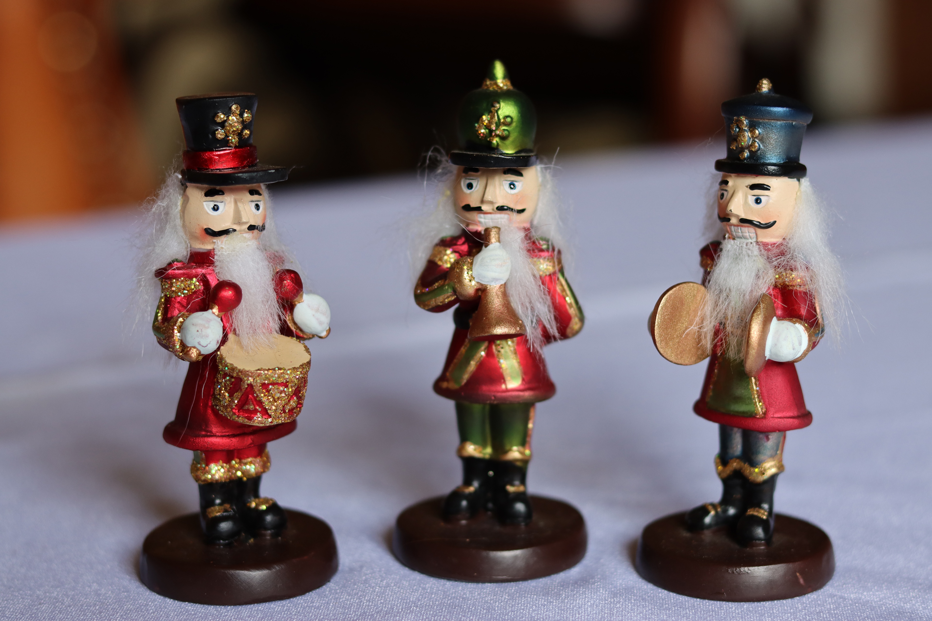 Three Nutcracker Figurines with Musical Instruments HD Wallpaper