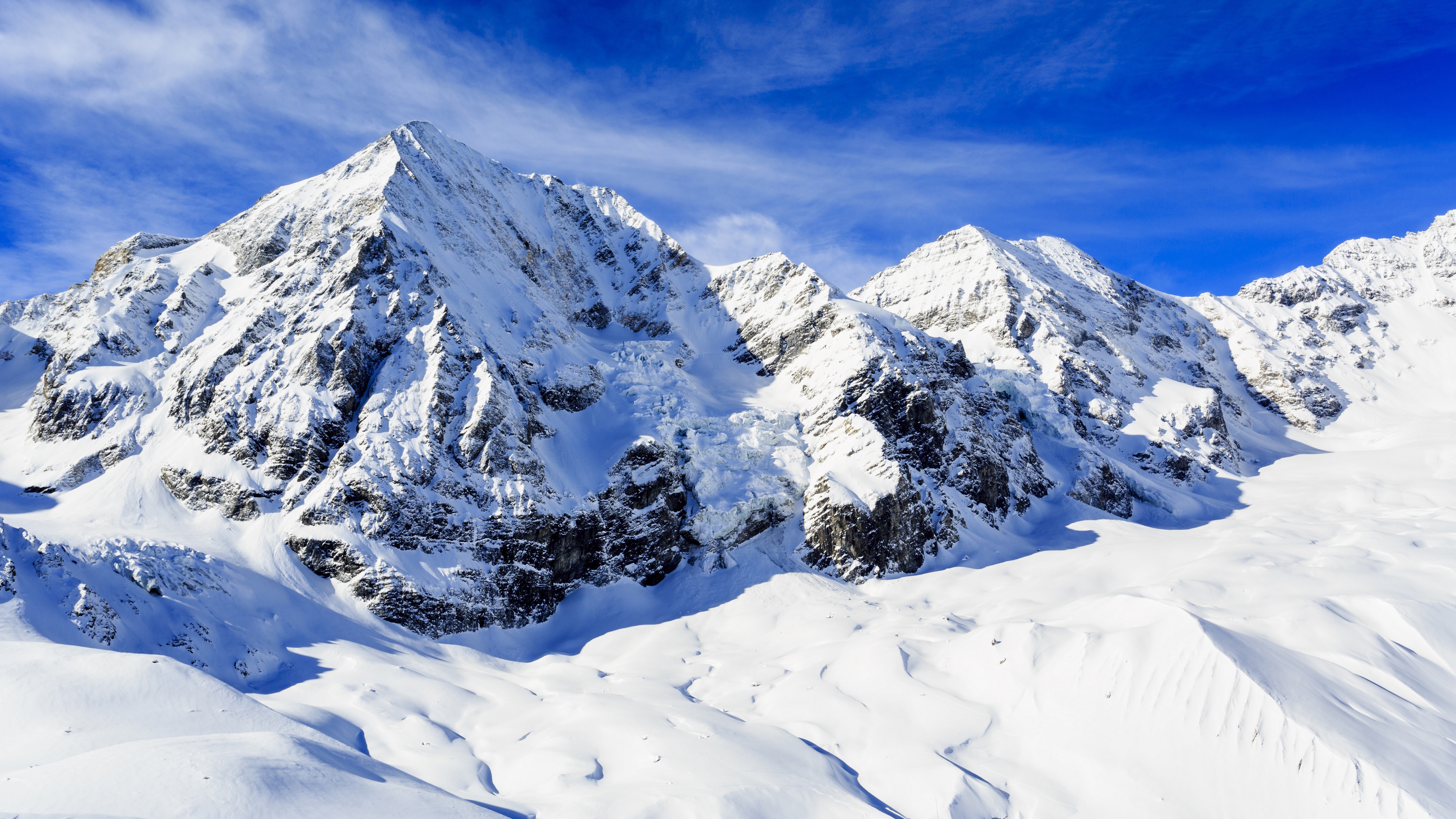 Snowy Mountains Under a Blue Sky 4K HD Wallpaper