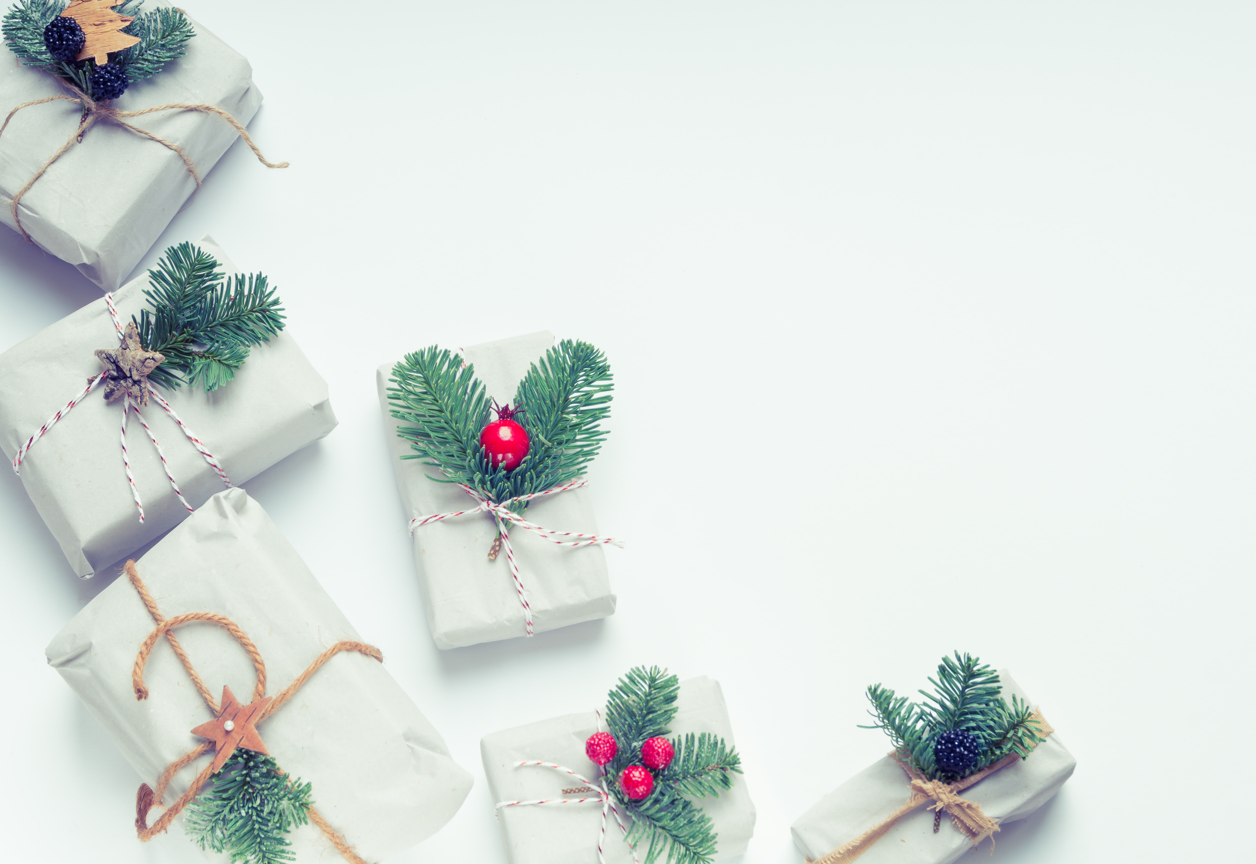 Christmas gifts wrapped in grey paper with pine branches HD Wallpaper