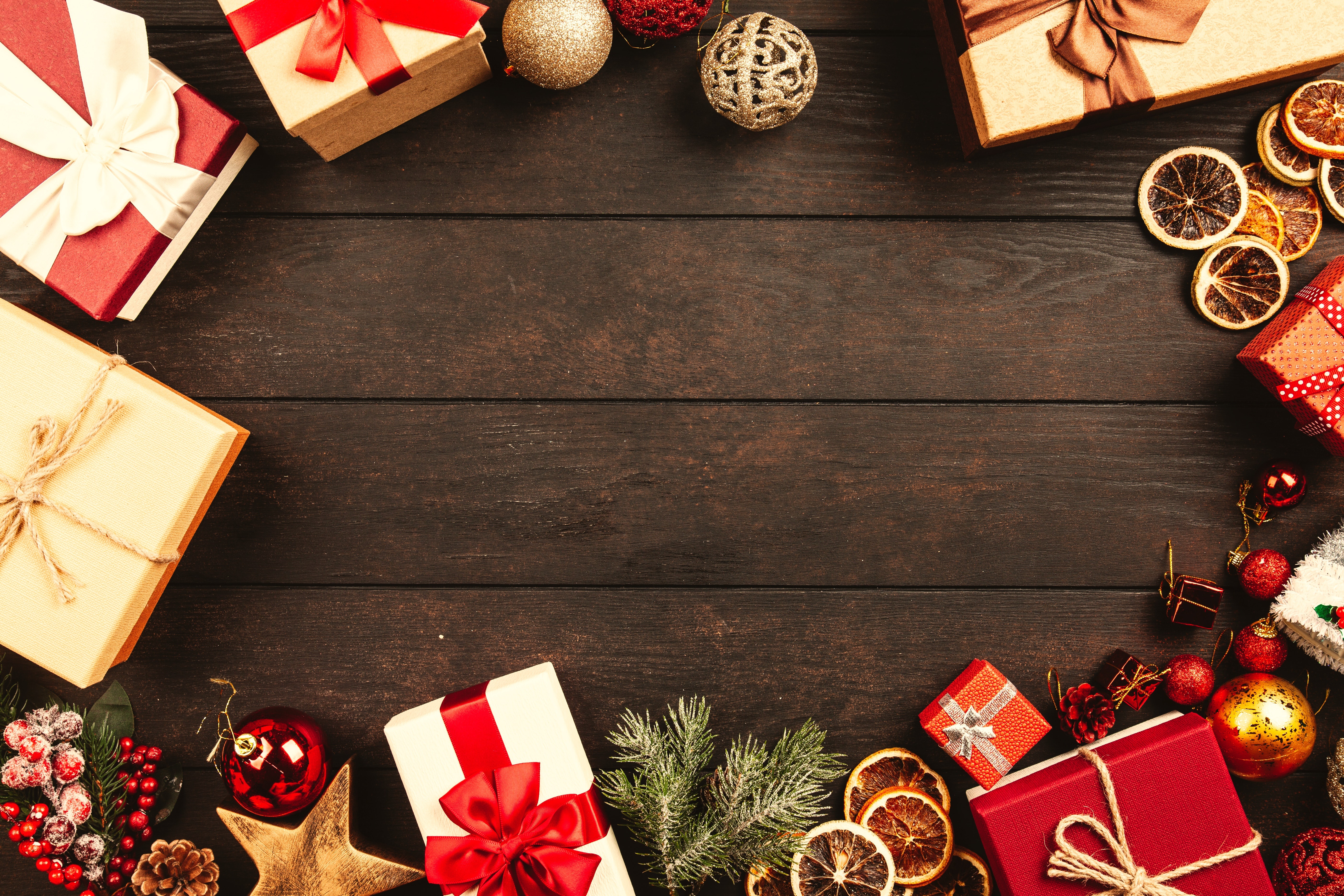 Christmas gifts and ornaments on wooden table HD Wallpaper