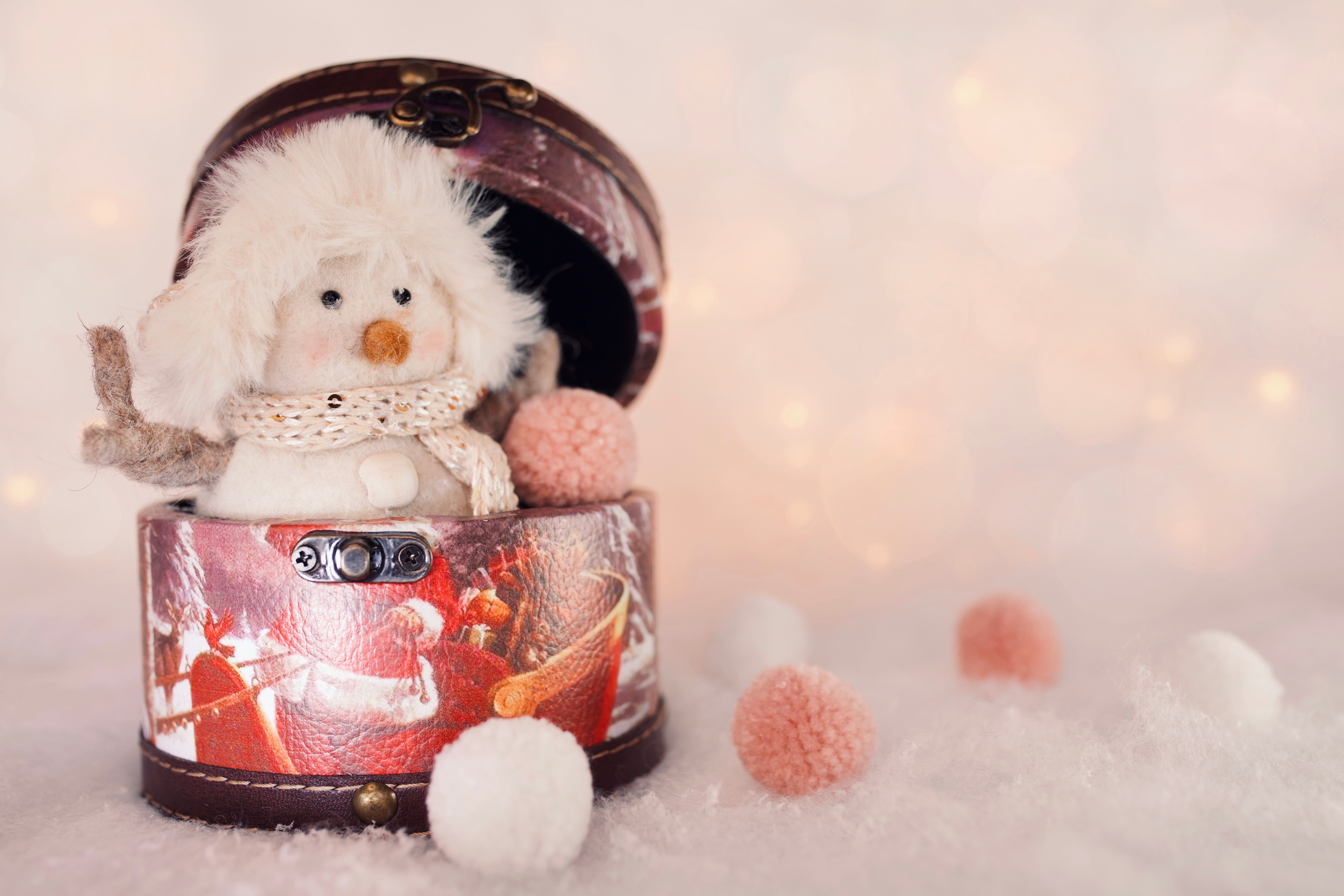 Snowman toy in a Christmas box with bokeh lights HD Wallpaper