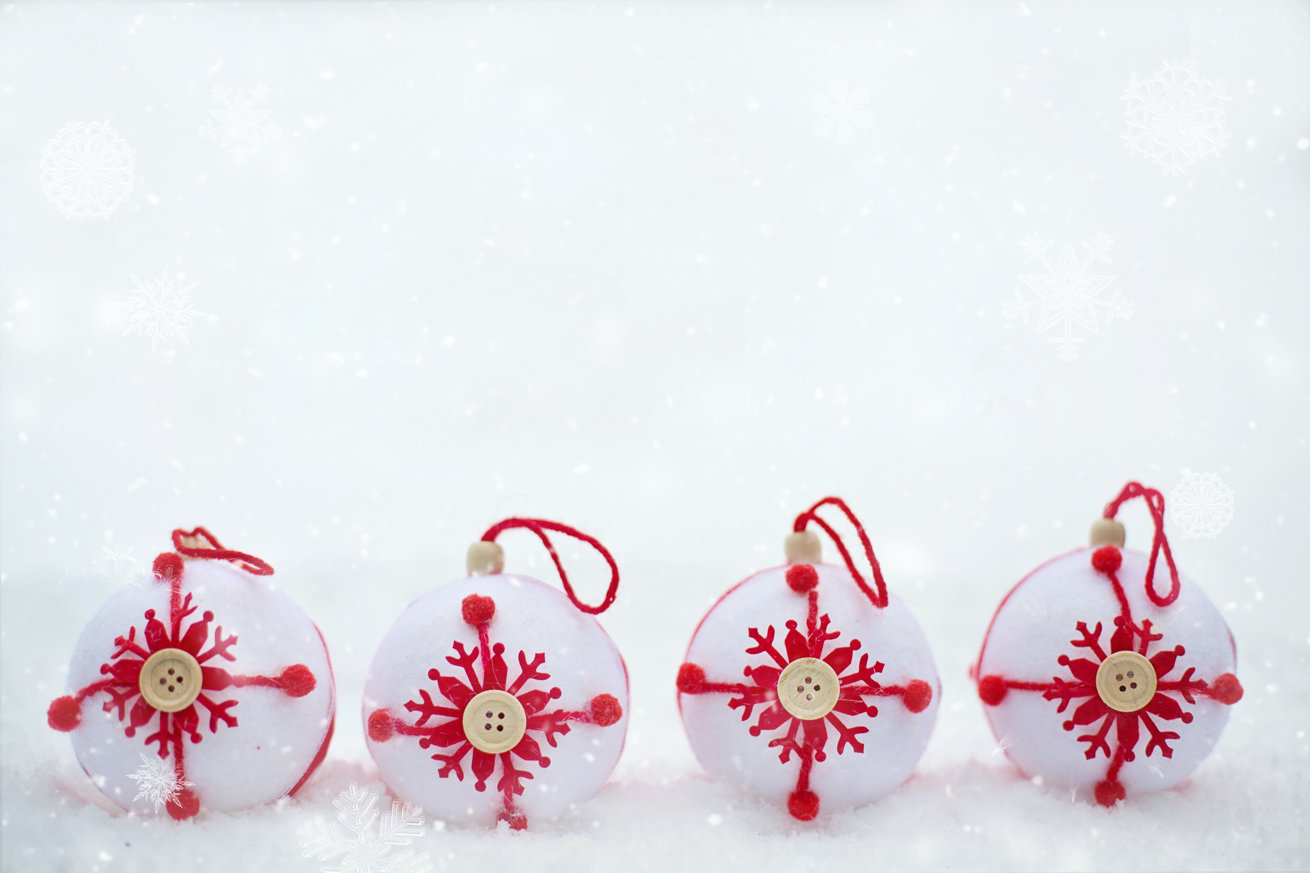 Four Christmas ornaments in snow HD Wallpaper