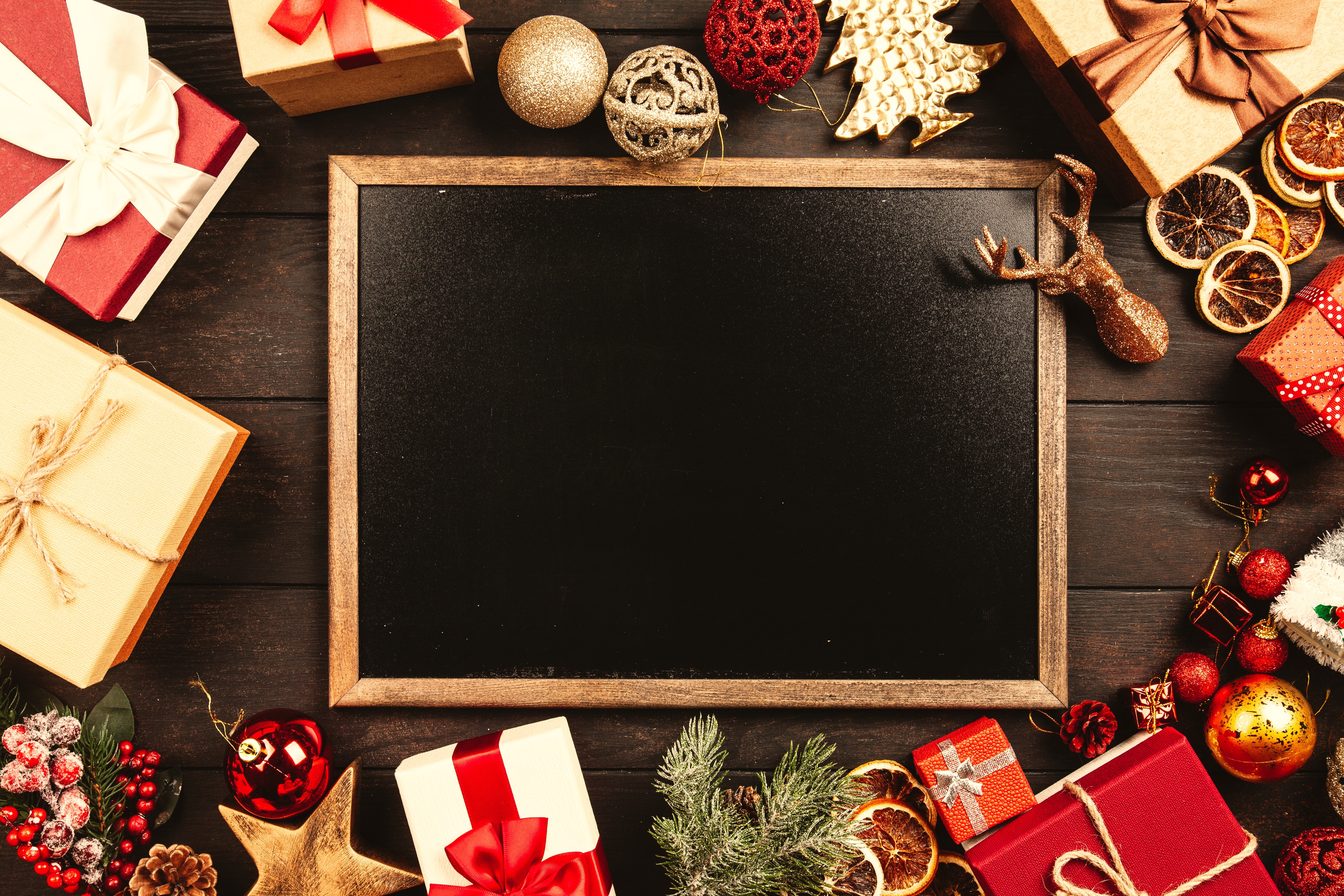 Christmas gifts and ornaments on a blackboard HD Wallpaper