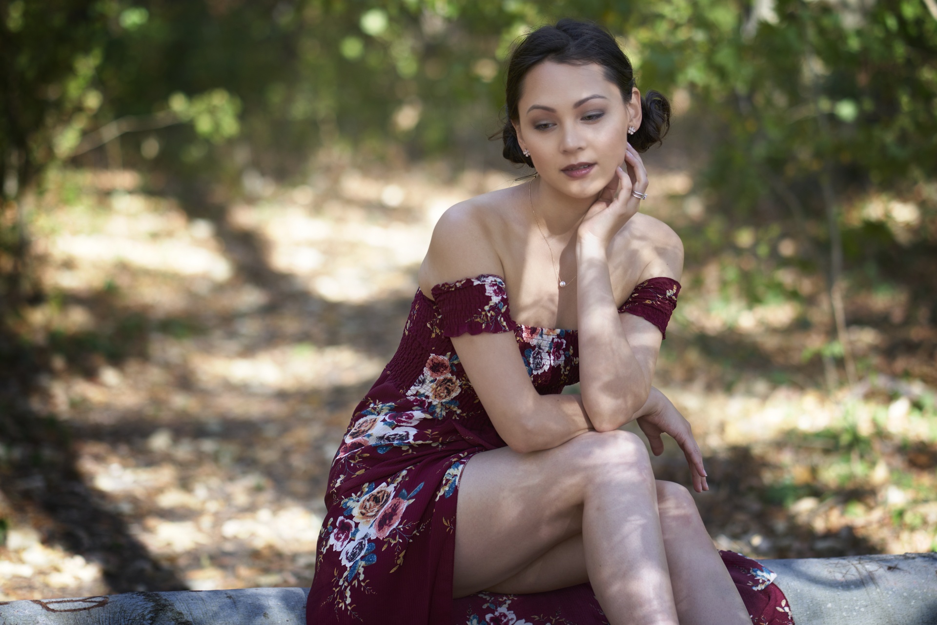 Model in a floral dress sitting outdoors HD Wallpaper