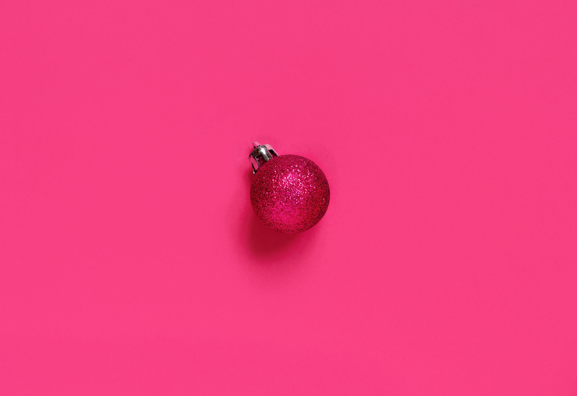 Pink glitter Christmas ornament on a pink background HD Wallpaper