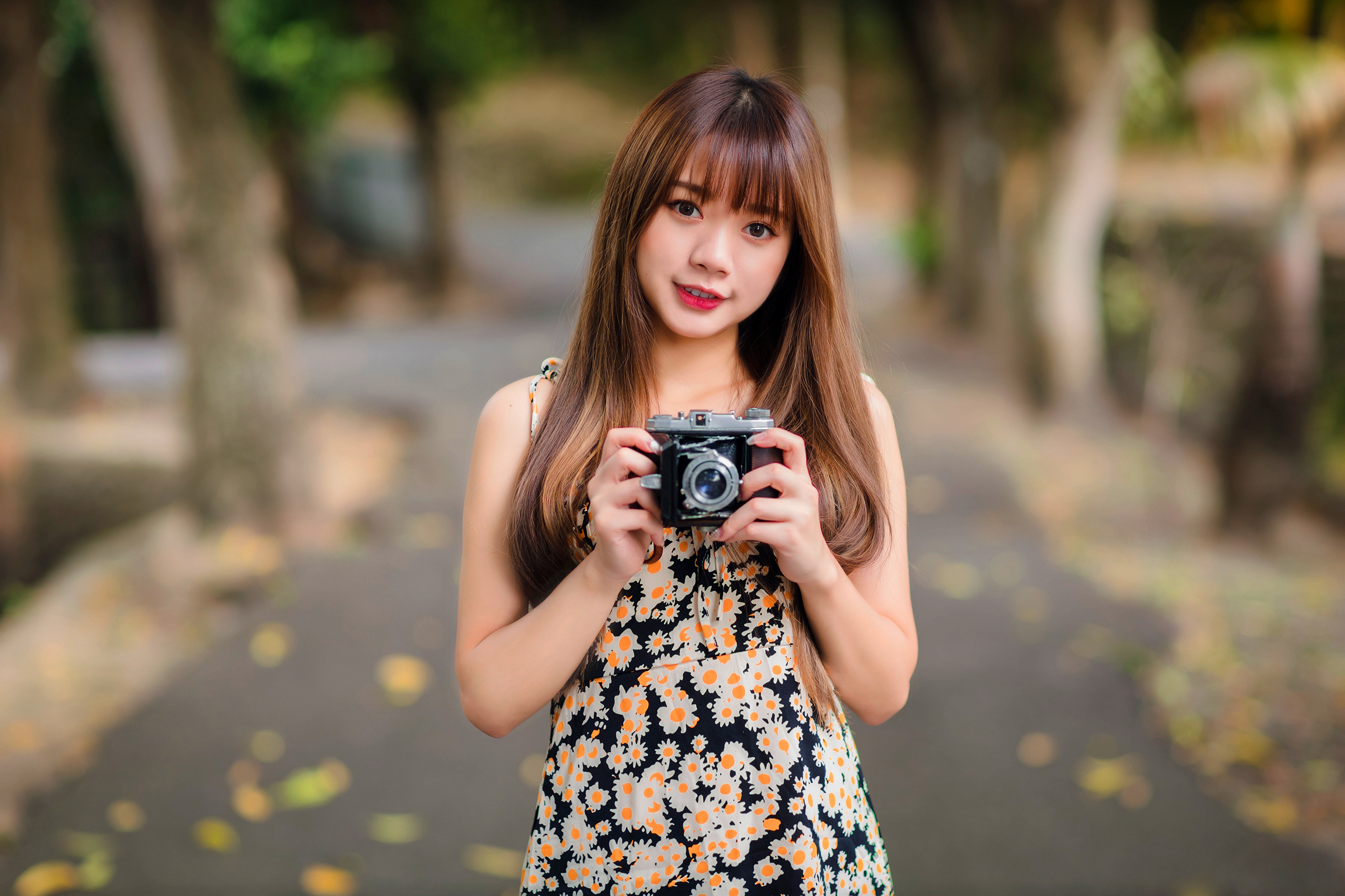 Asian woman holding a vintage camera HD Wallpaper