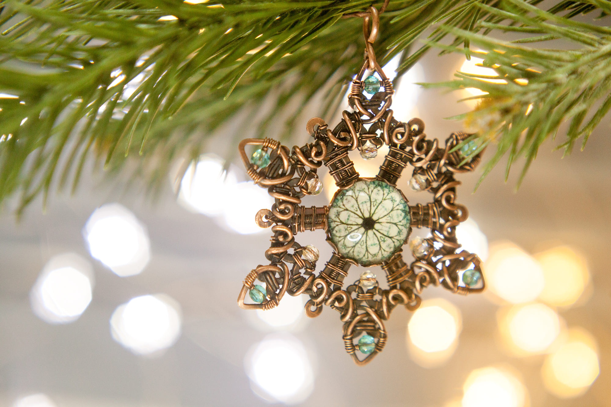 Wire-wrapped snowflake ornament with blue beads HD Wallpaper