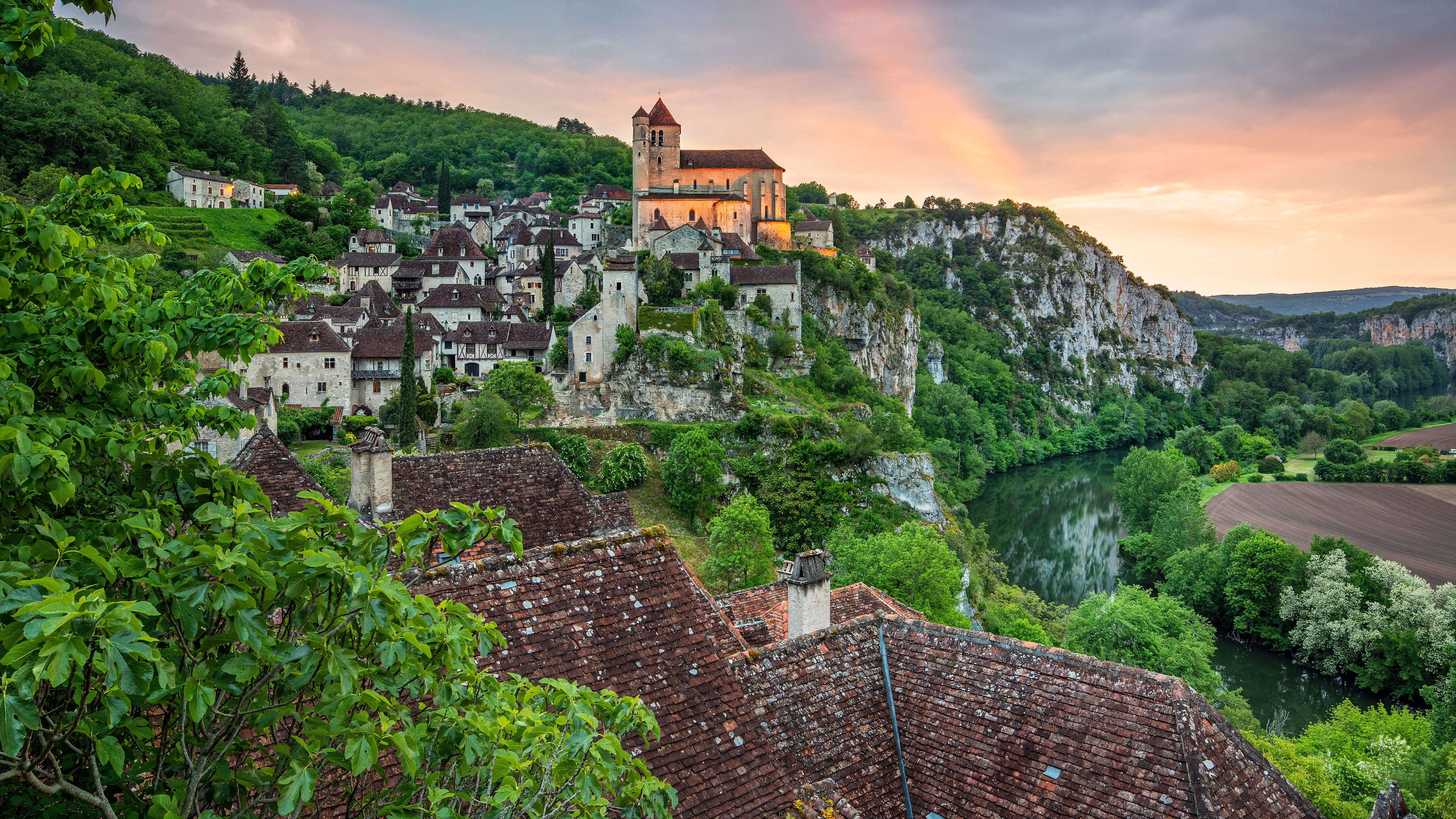 Village with castle on cliff overlooking river in France 4K HD Wallpaper