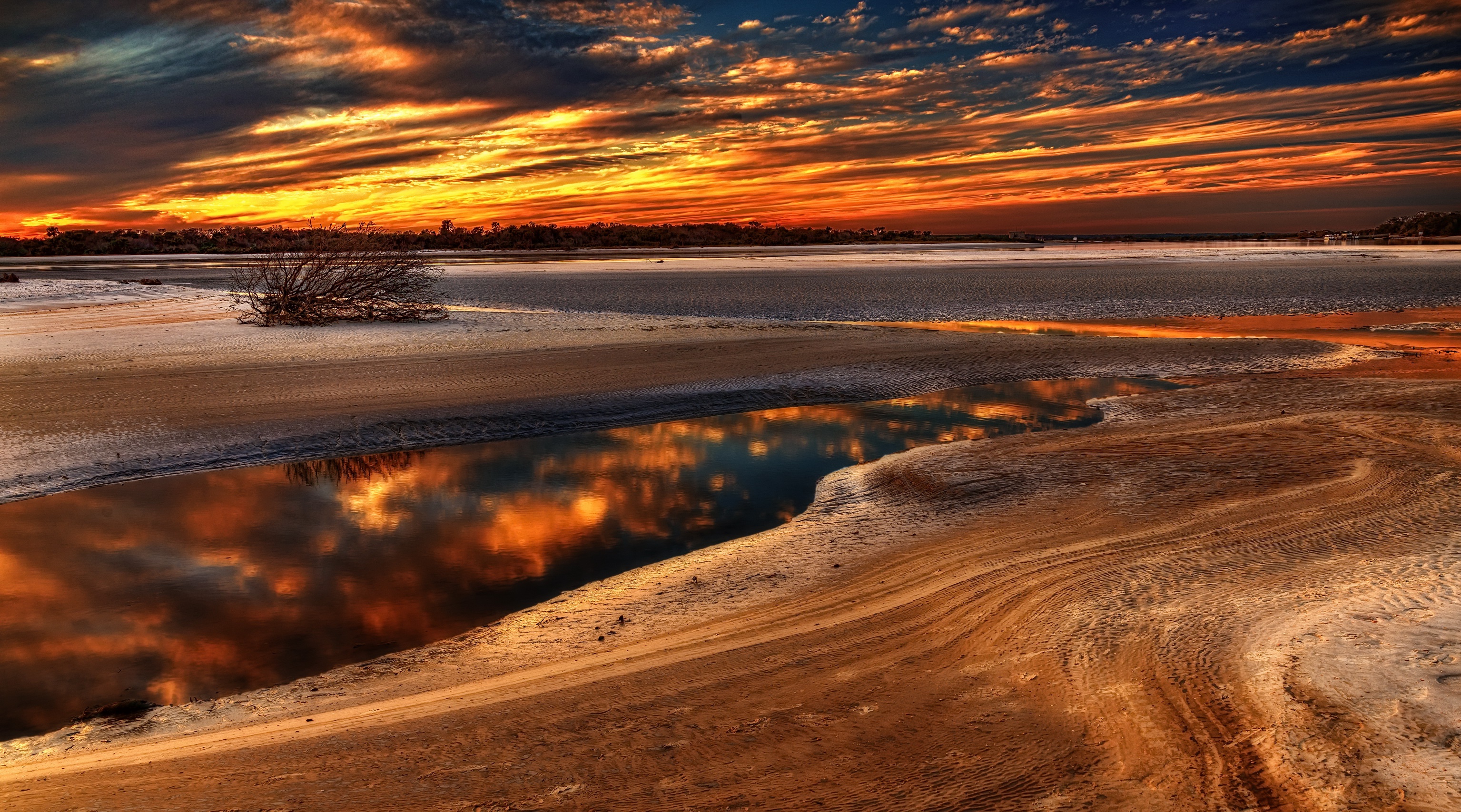 Sunset over a body of water with reflections HD Wallpaper