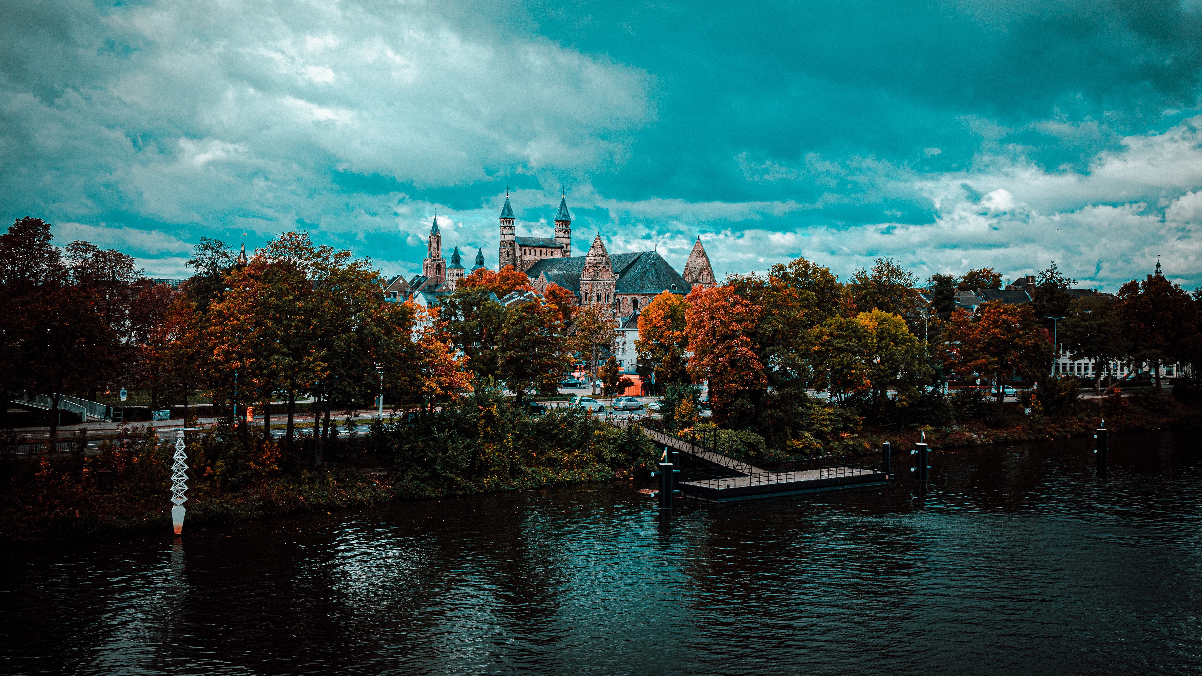 Castle by the river in fall with dramatic clouds HD Wallpaper