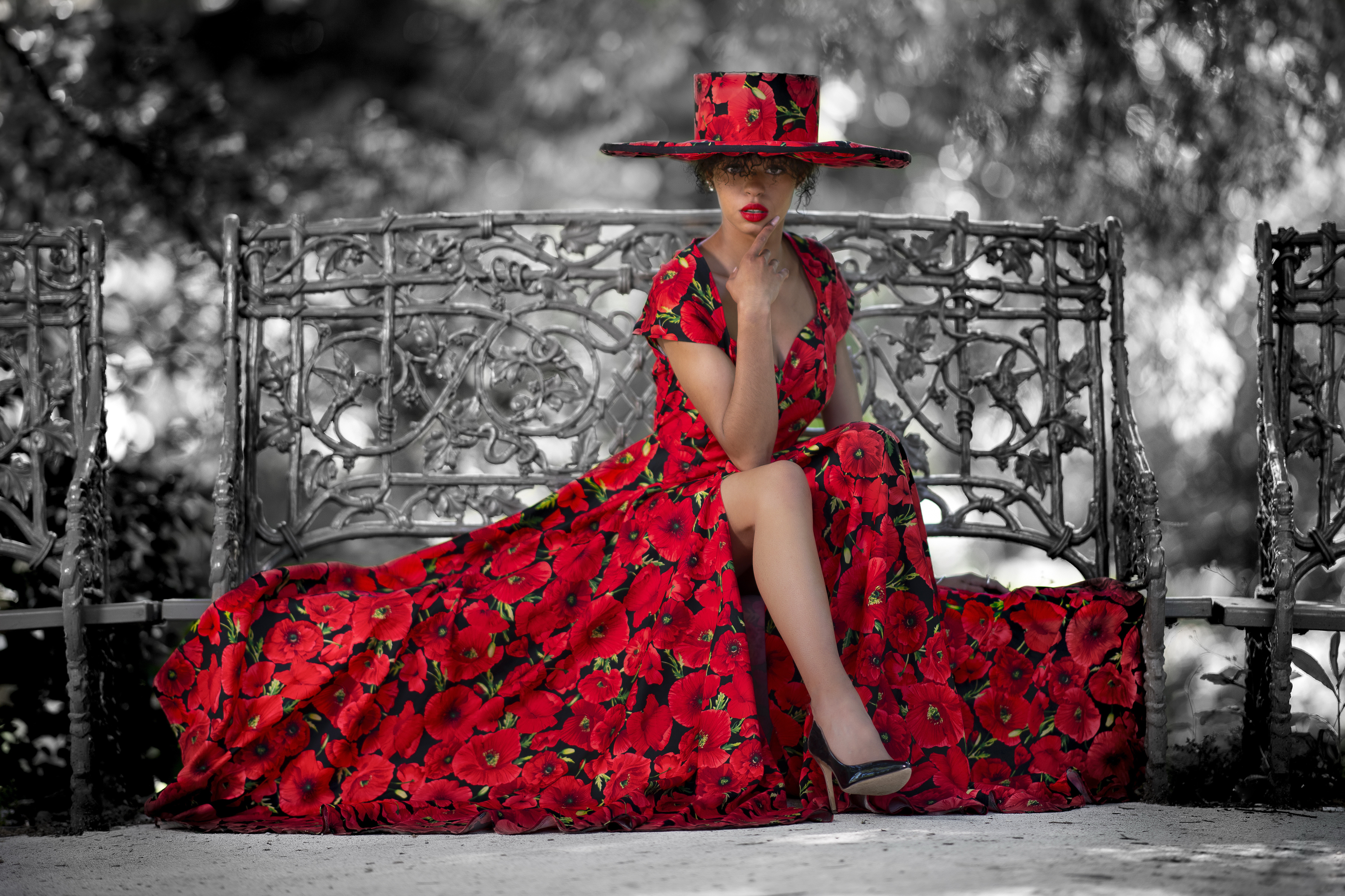 Woman in poppy dress and hat on bench HD Wallpaper