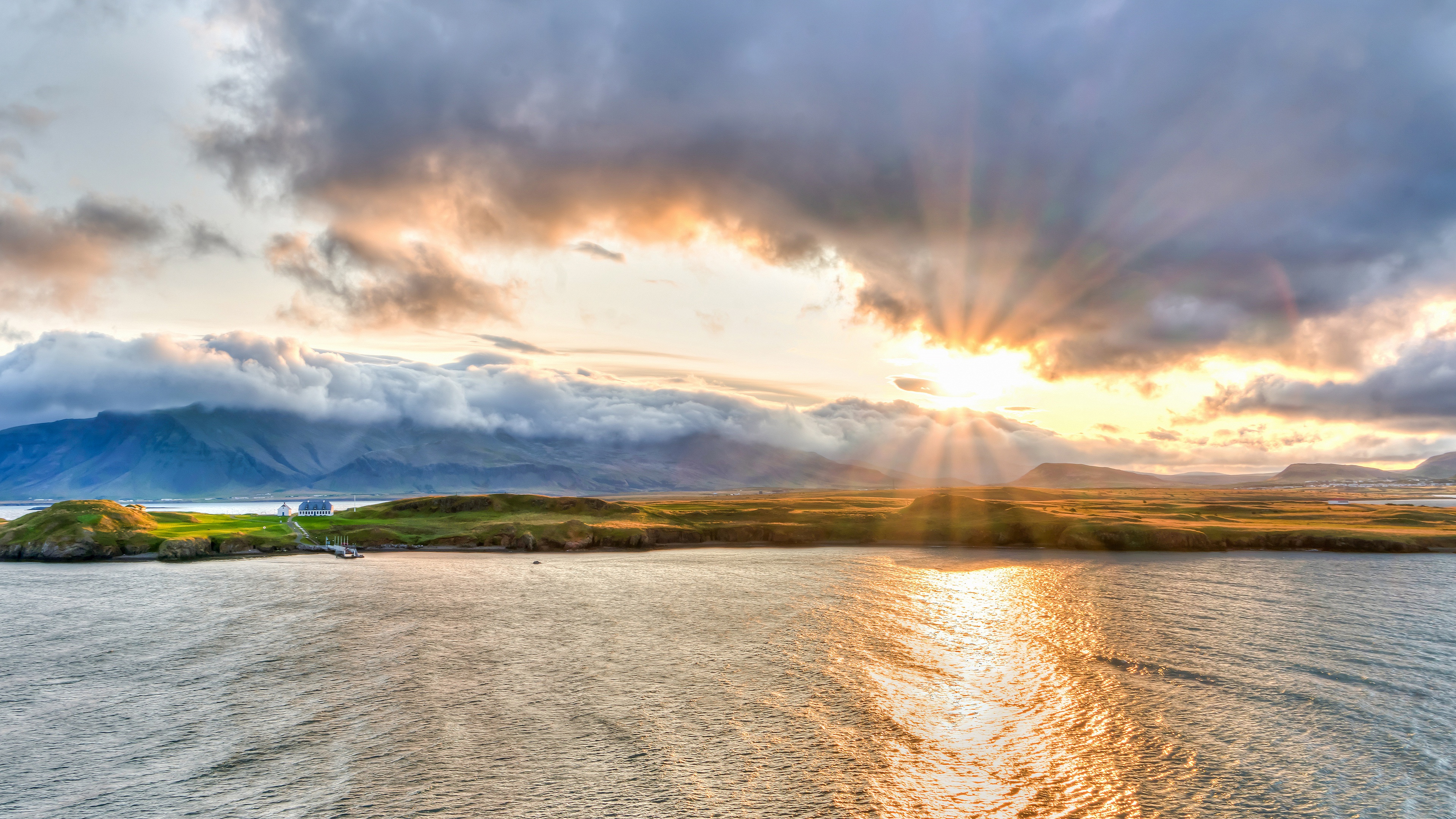 Sunbeams through clouds over mountains and sea HD Wallpaper
