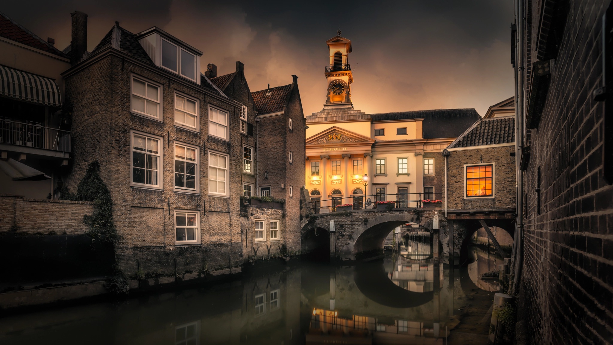 Canal with bridge and buildings in Netherlands at dusk HD Wallpaper