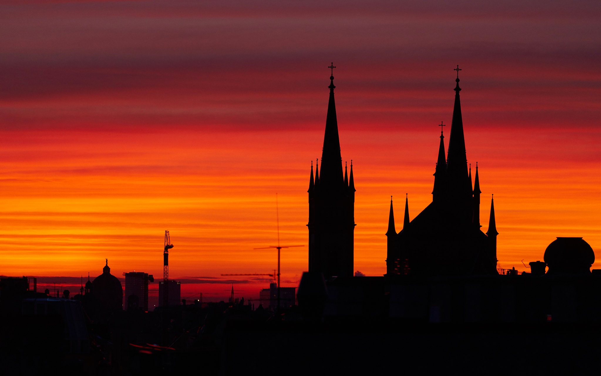 Church silhouette against a vibrant sunset in Vienna, Austria HD Wallpaper