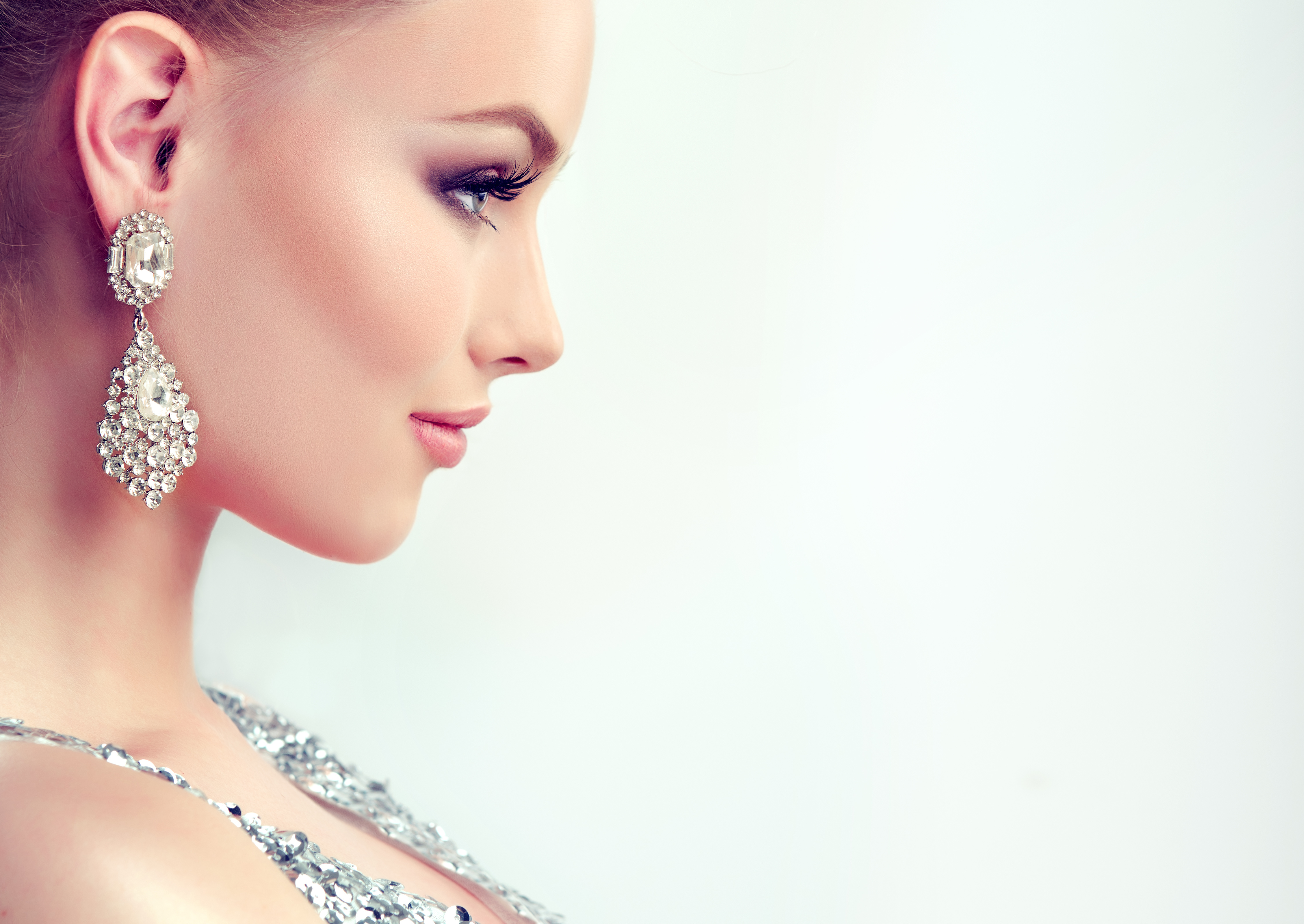Elegant Model Profile with Makeup and Earrings in HD Wallpaper