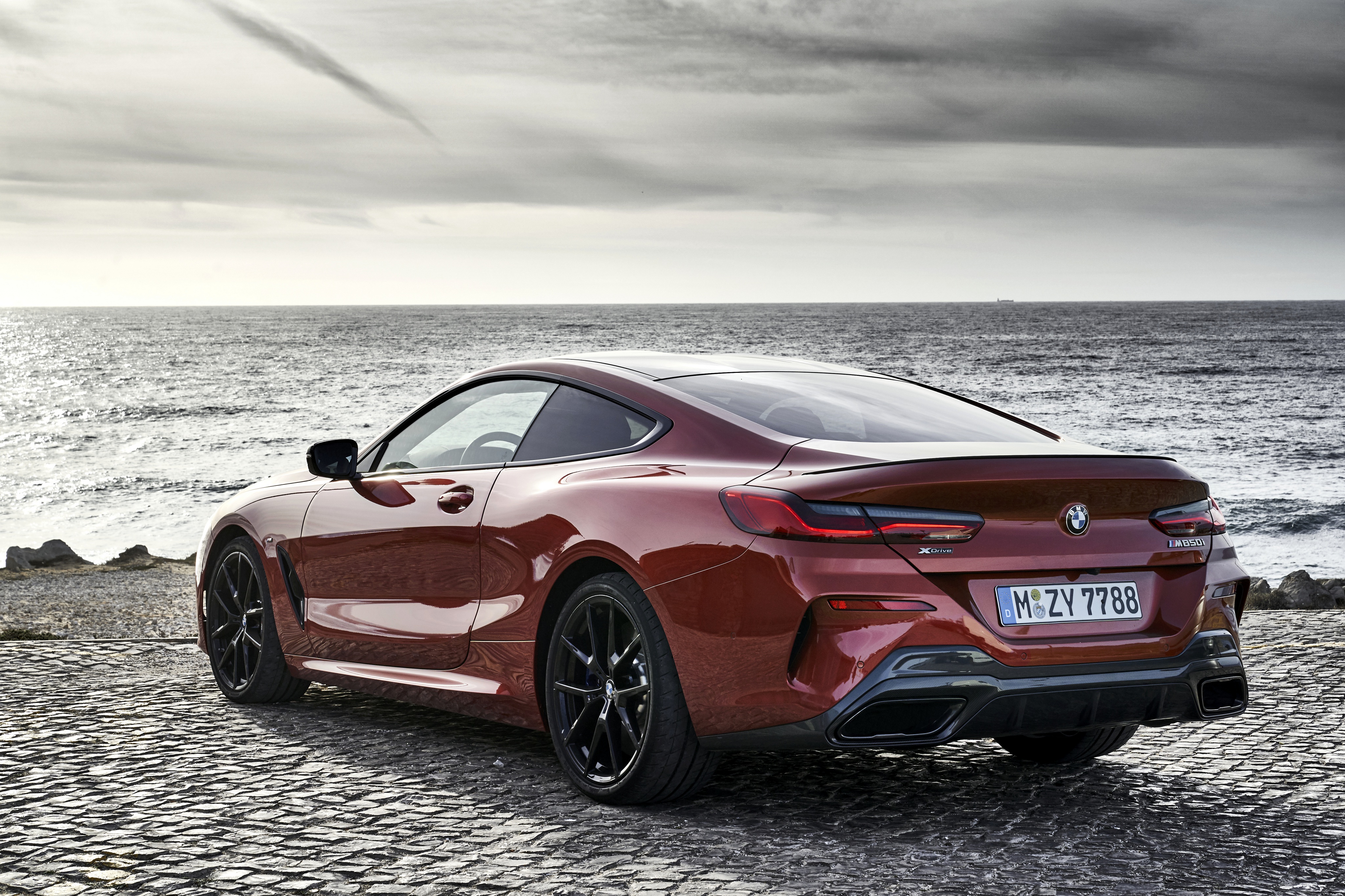 Red BMW M850i parked by the sea HD Wallpaper
