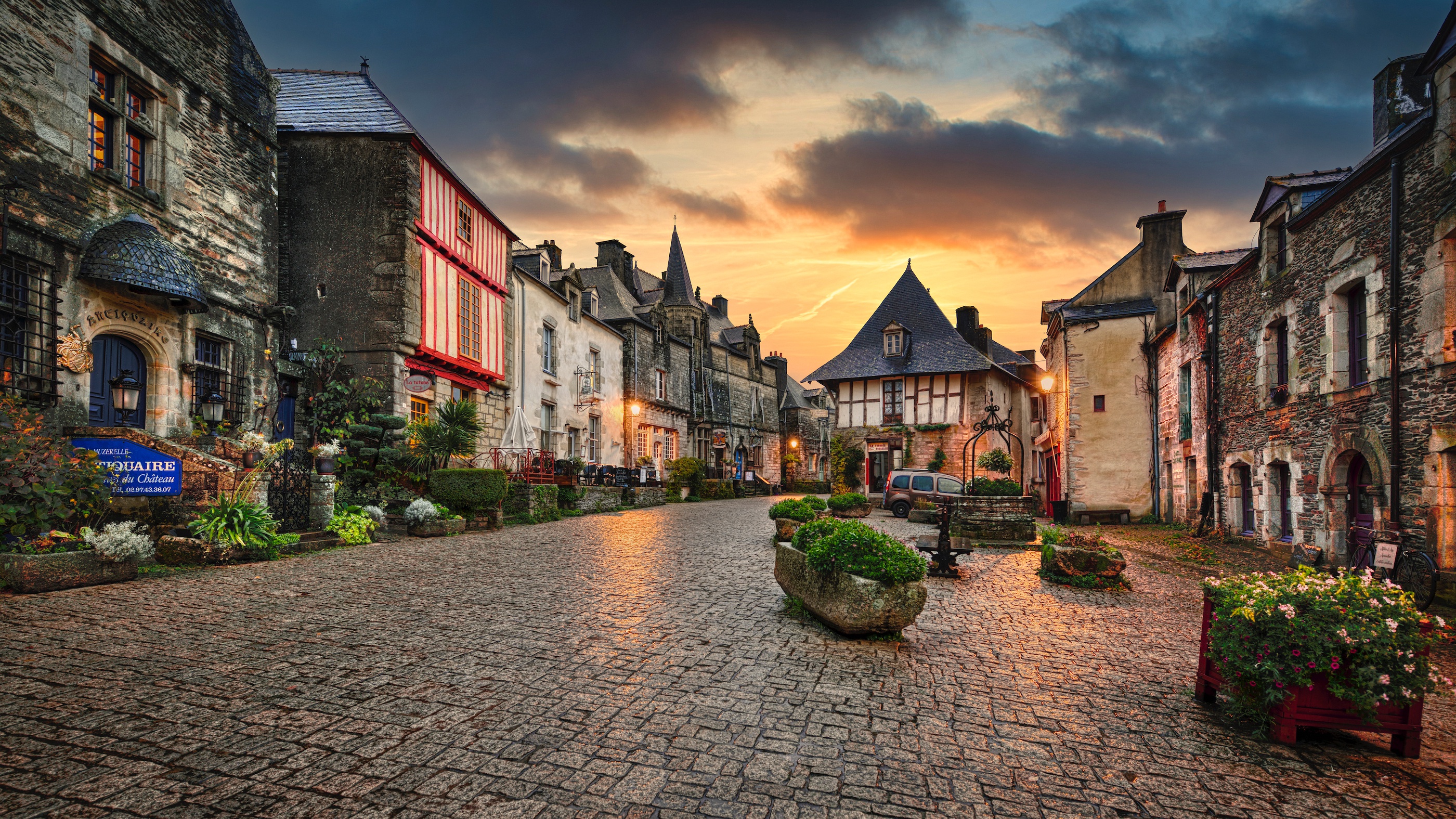 Historic village street at sunset in Rochefort-en-Terre, France HD Wallpaper