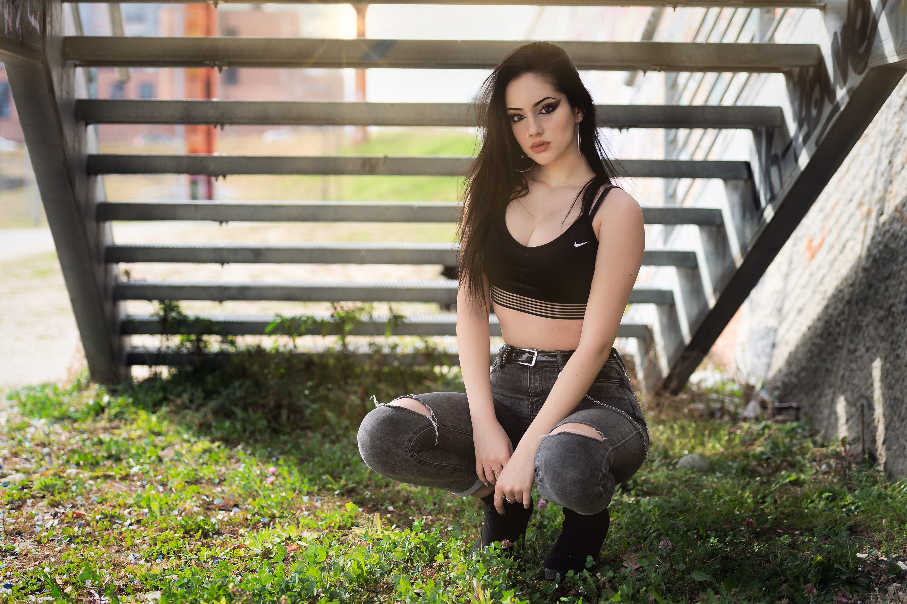 Woman with long black hair wearing a sports bra and ripped jeans HD Wallpaper