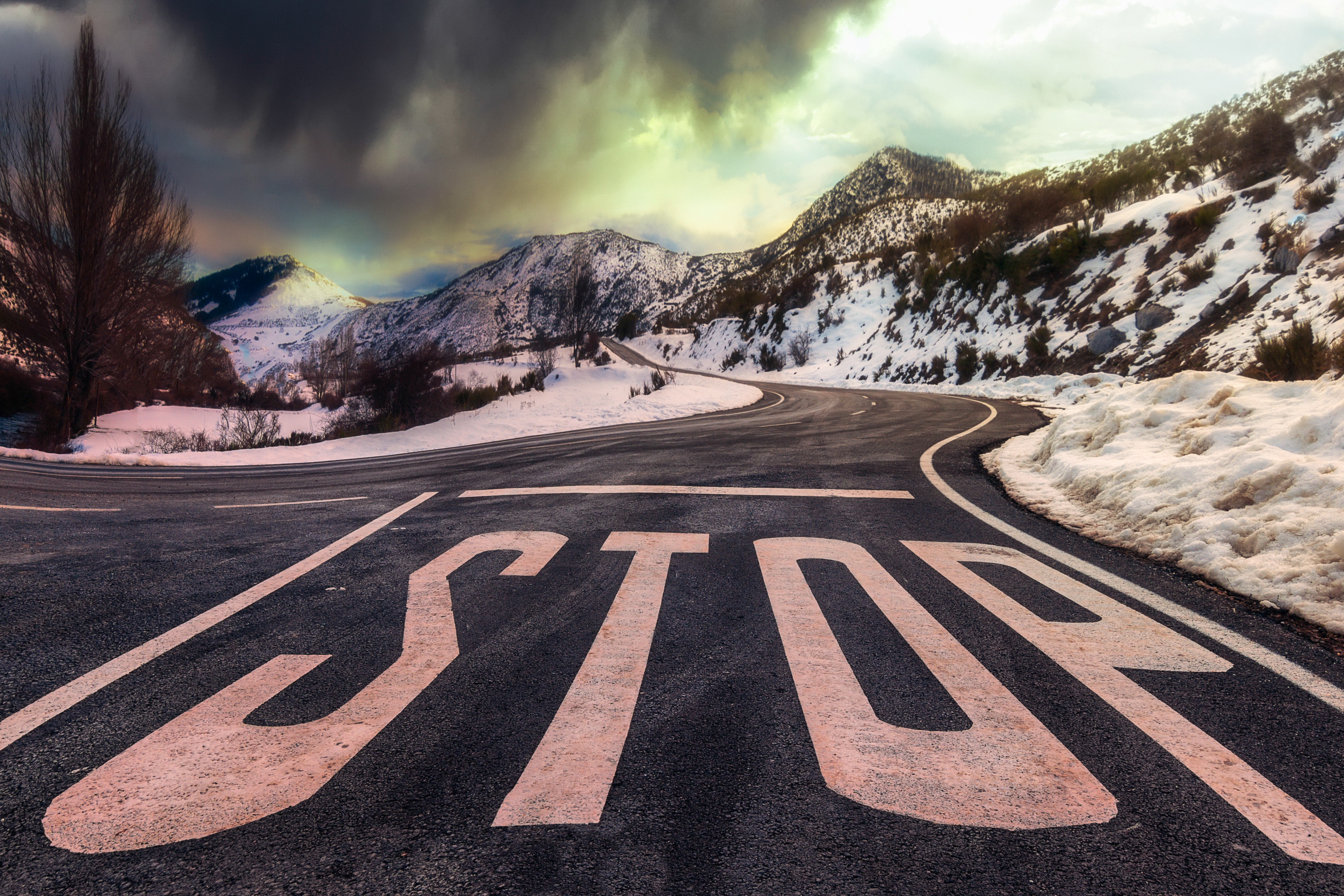 Stop Sign on Snowy Mountain Road 4K HD Wallpaper