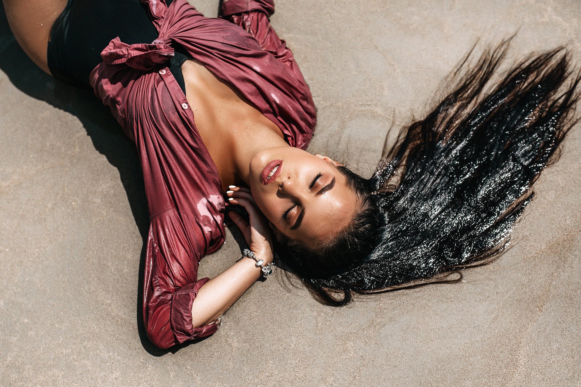 Woman in wet shirt lying on sand HD Wallpaper