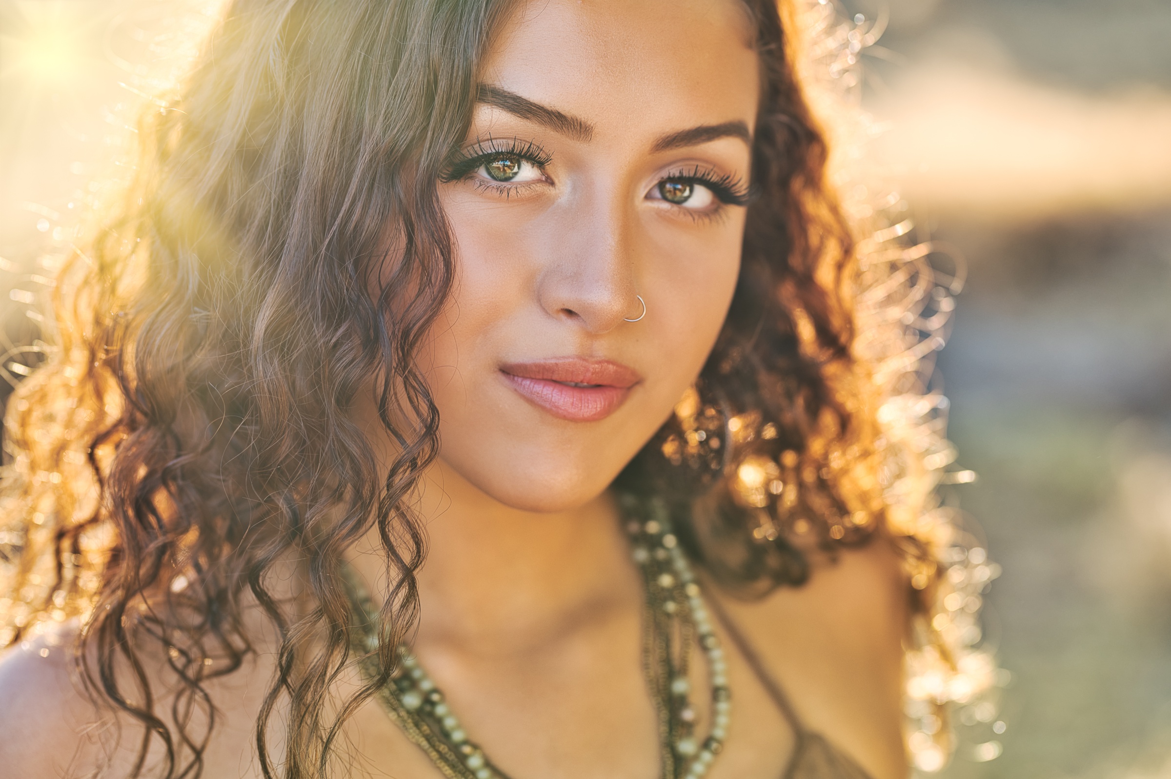 Woman with curly hair and nose piercing HD Wallpaper