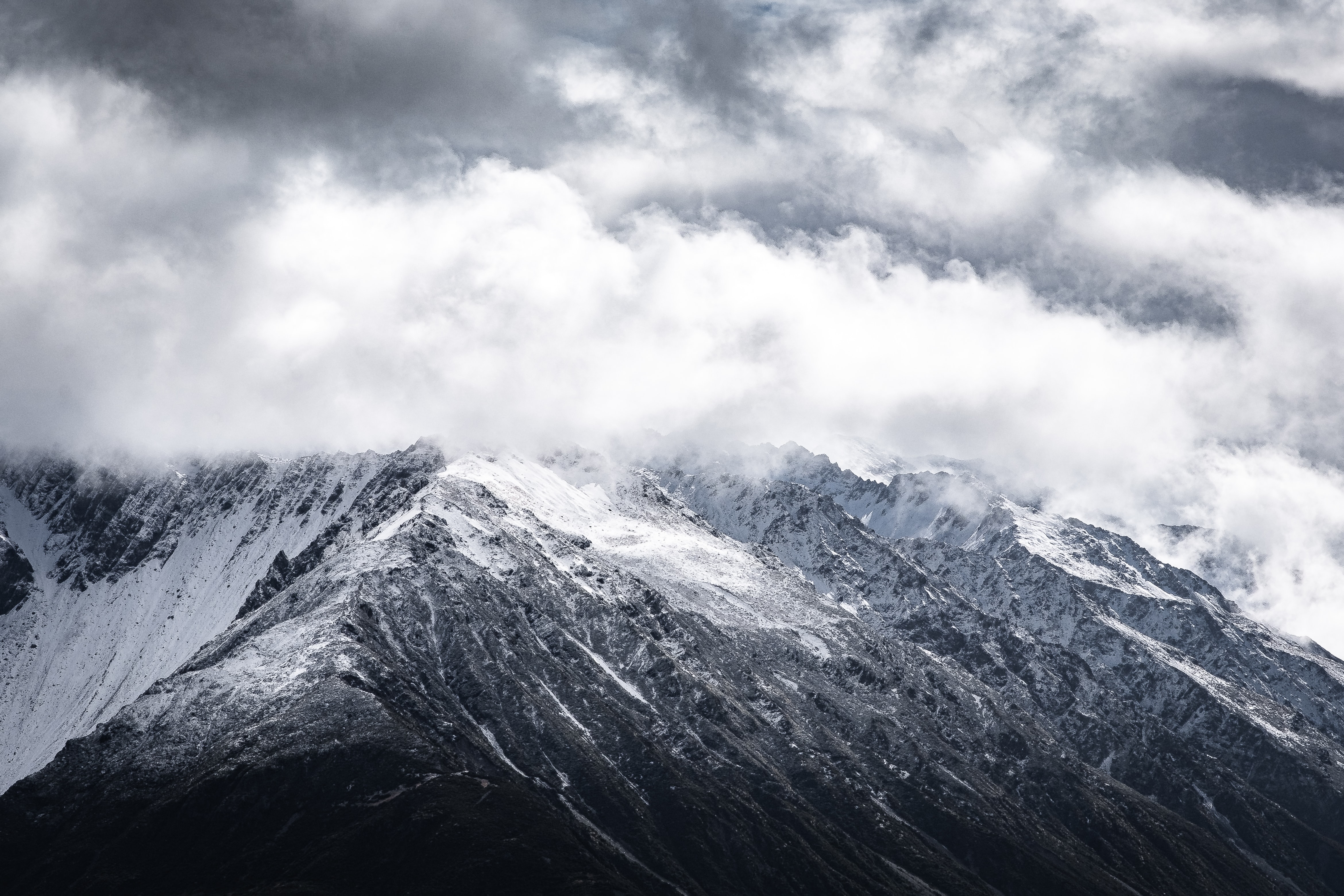 Snow-covered mountain peak with clouds HD Wallpaper