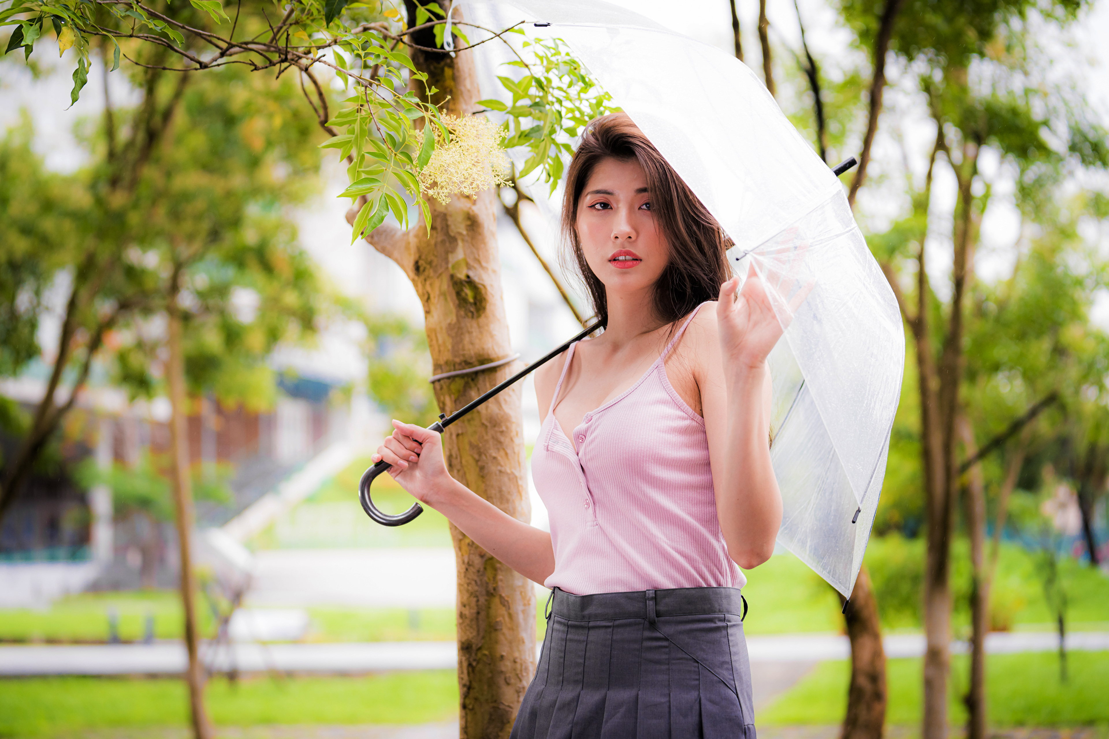 Asian woman holding umbrella in park HD Wallpaper