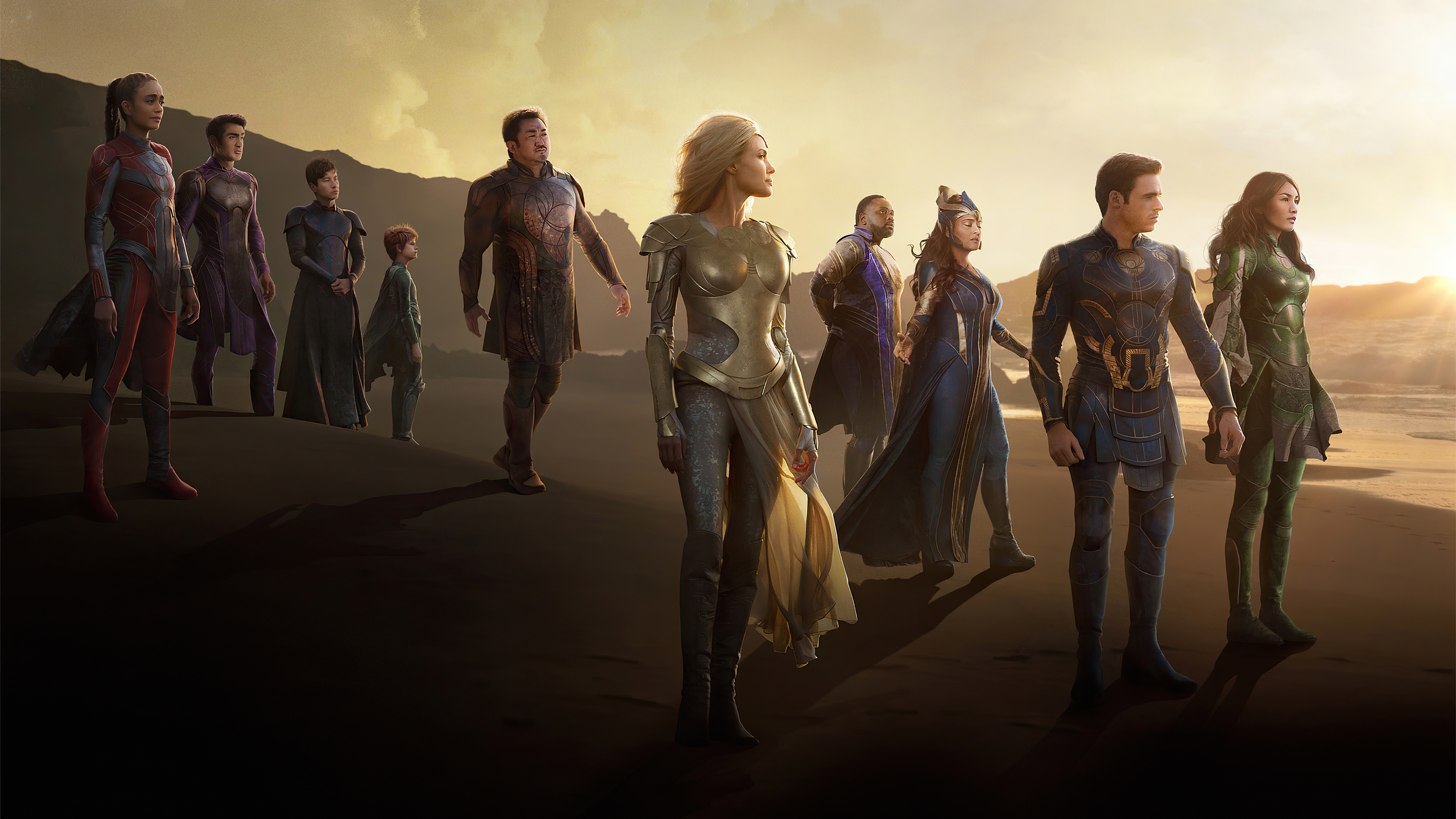 The Eternals standing on a beach at sunset HD Wallpaper