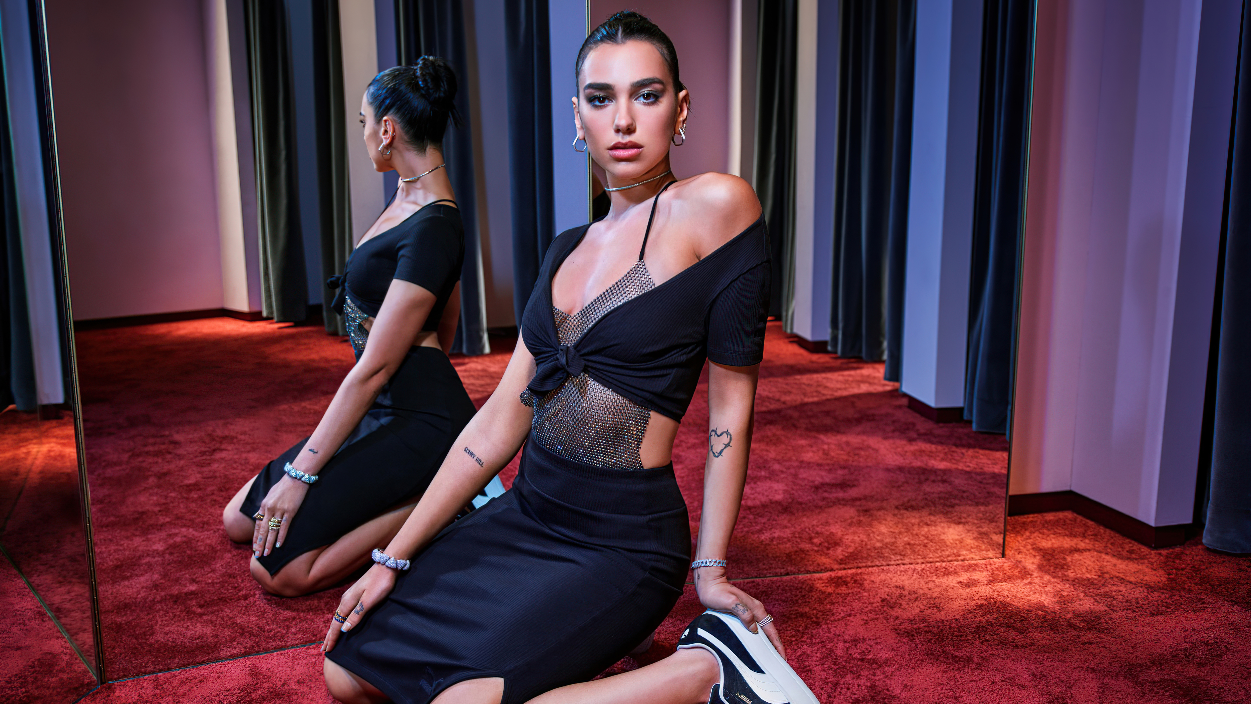 Dua Lipa in a black dress posing in a studio HD Wallpaper