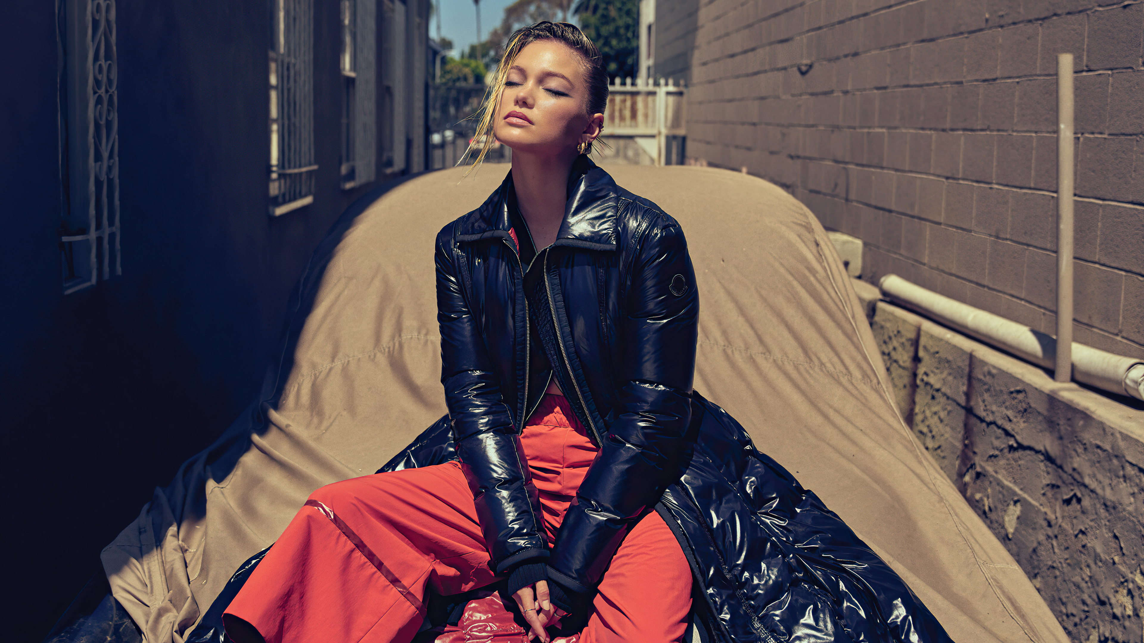 Olivia Holt in a Black Puffer Coat and Orange Pants HD Wallpaper