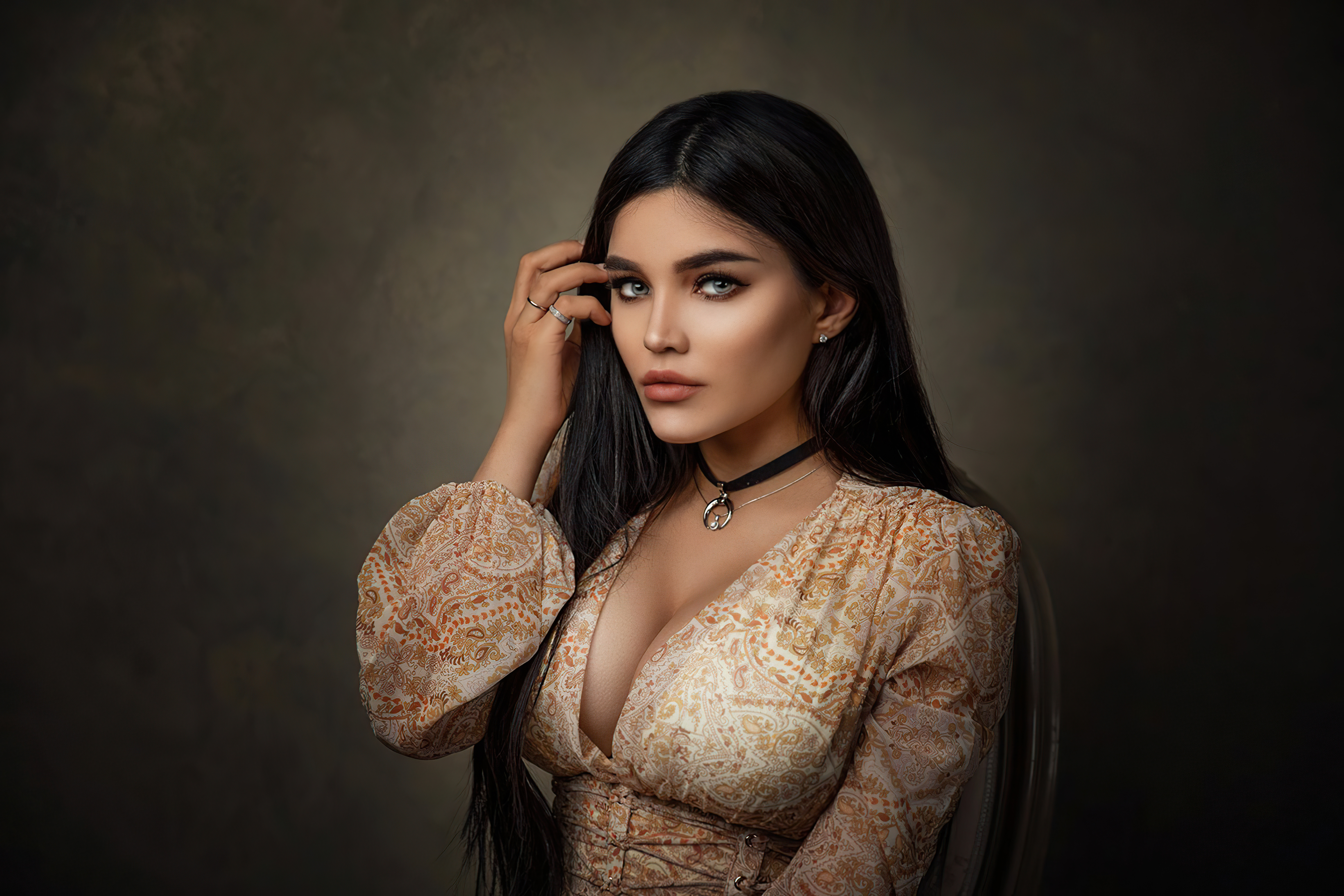 Elegant woman with dark hair in a patterned dress HD Wallpaper