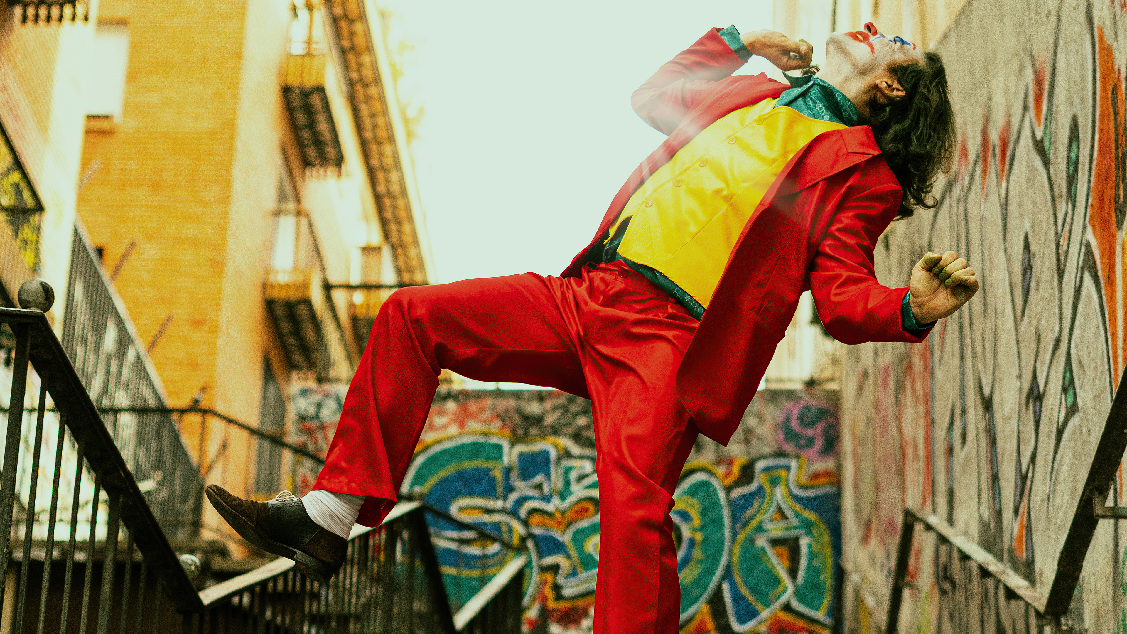 Joker in red suit dancing on stairs HD Wallpaper