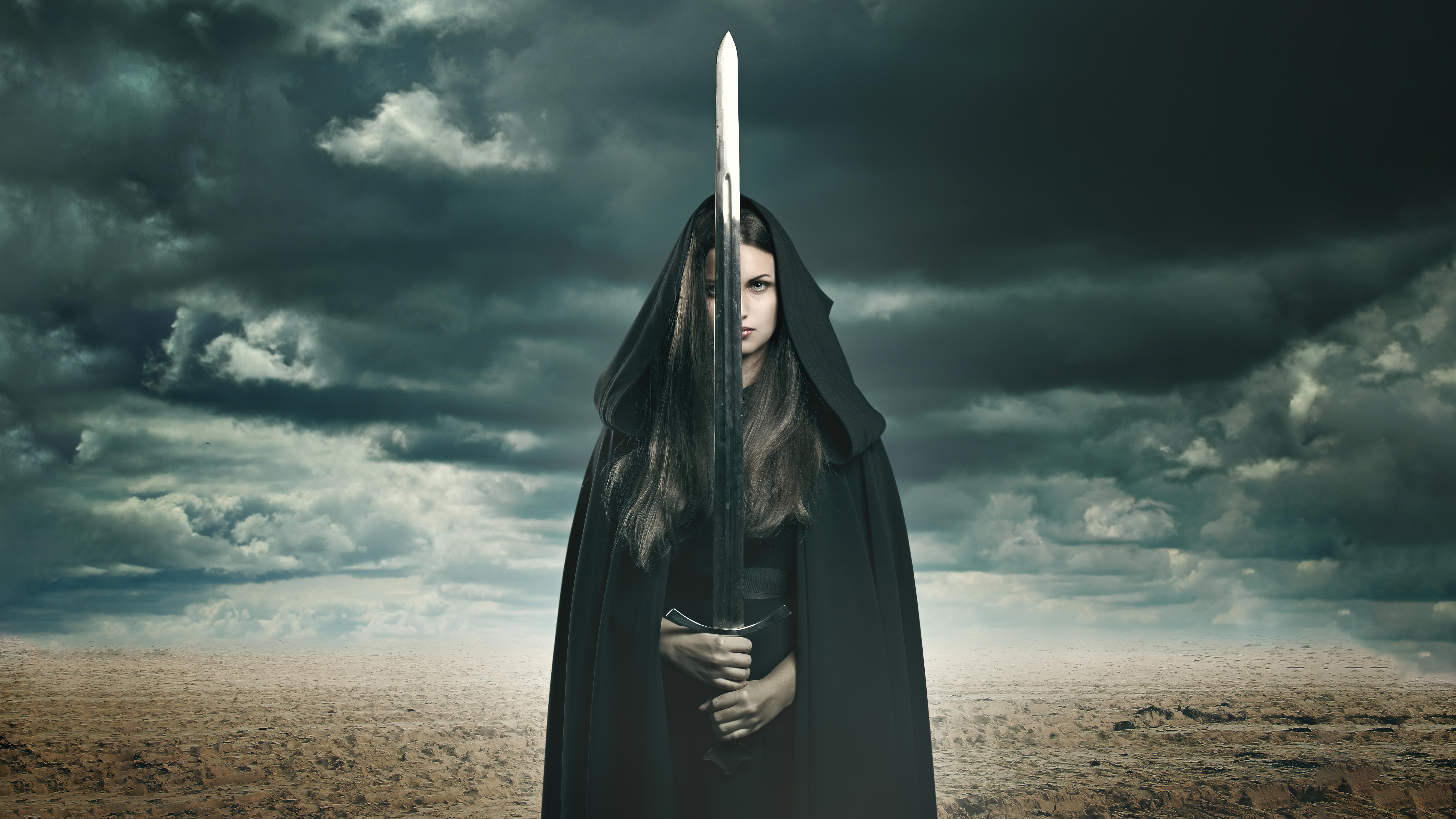 Warrior woman with sword under stormy sky HD Wallpaper