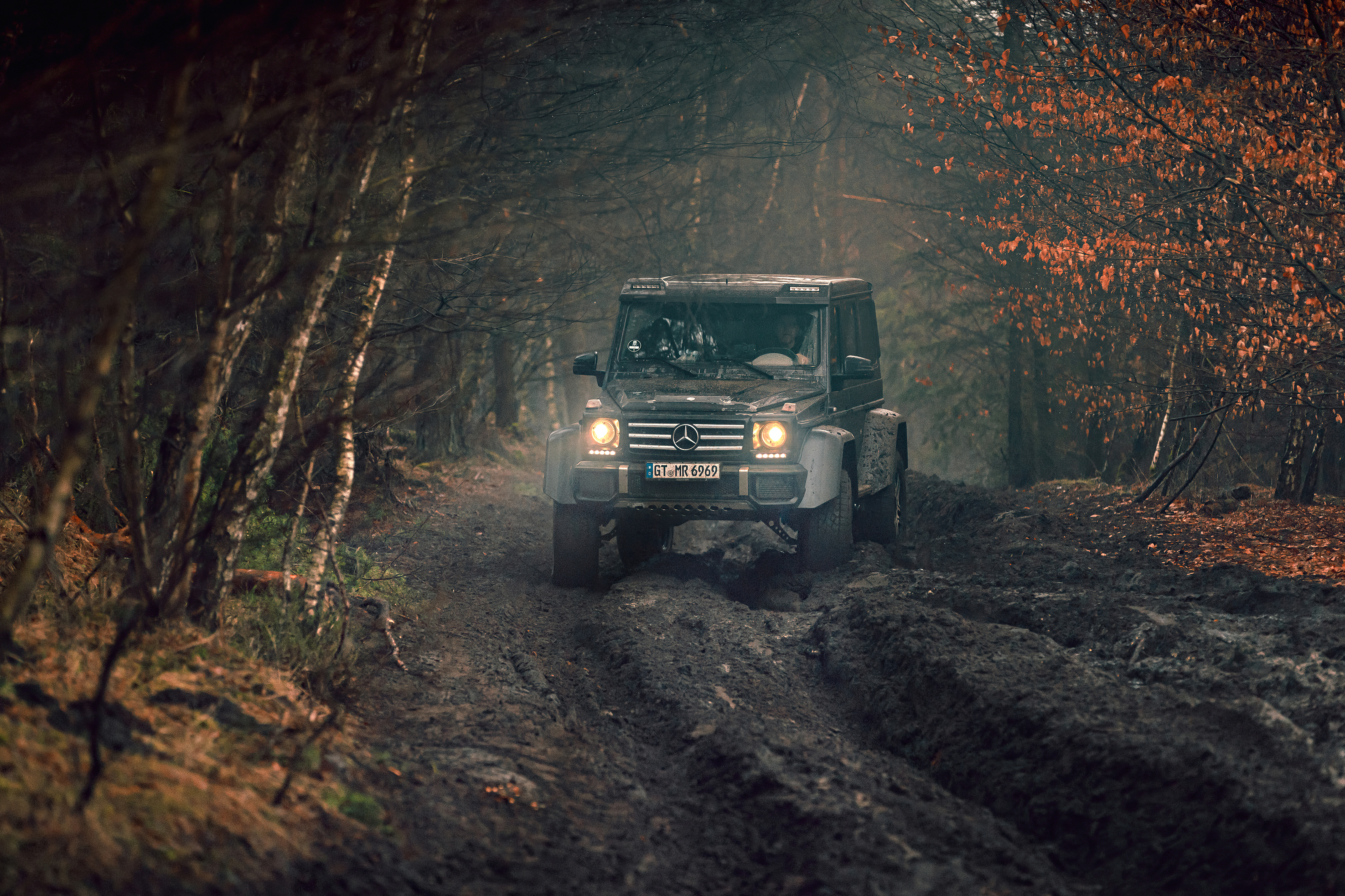 Mercedes G-Class driving on a muddy forest road HD Wallpaper