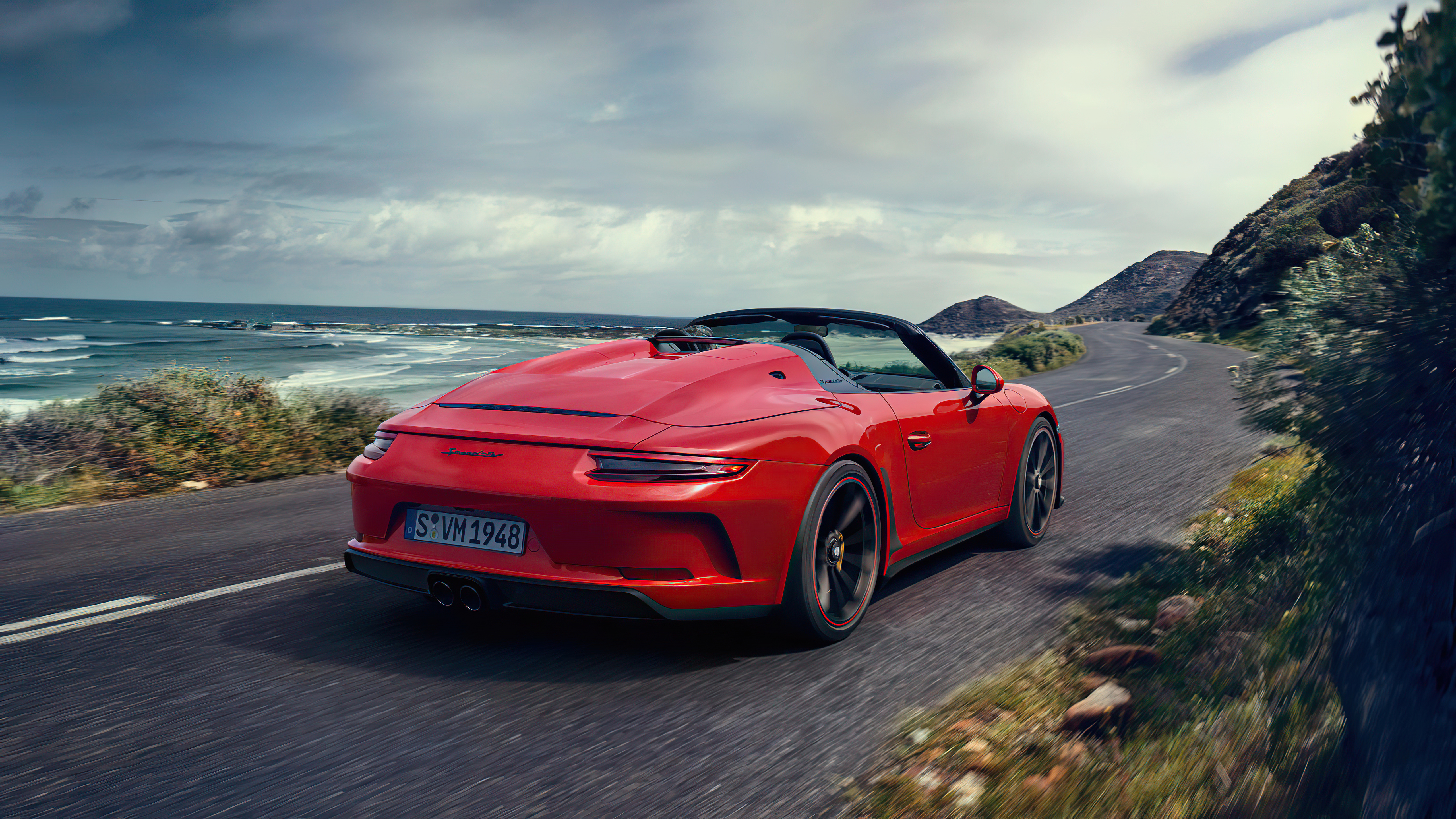 Red Porsche 911 Speedster driving on coastal road HD Wallpaper