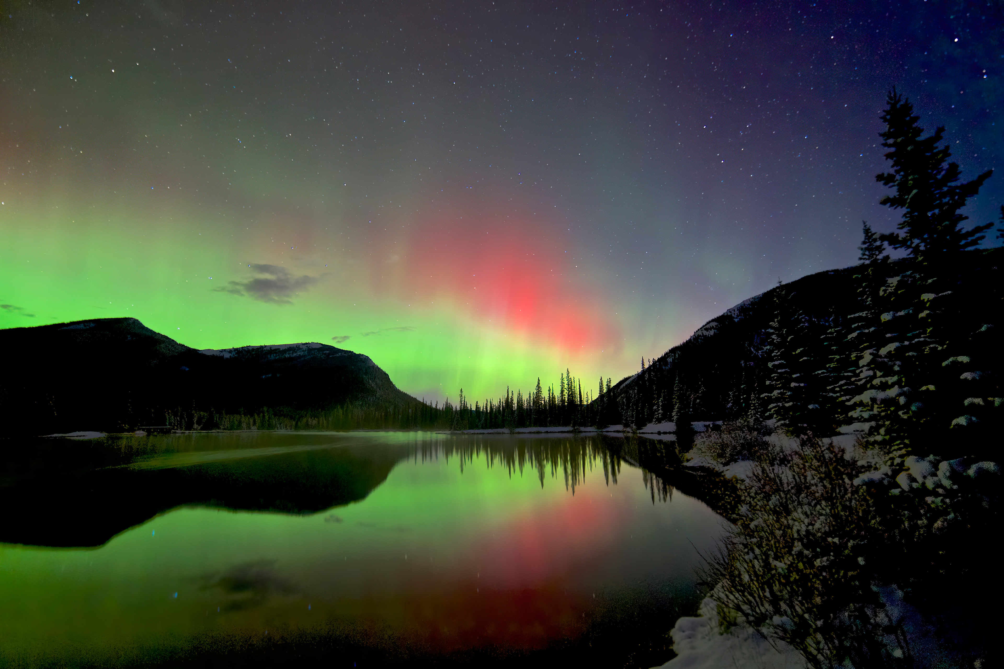 Aurora Borealis over a lake and mountains HD Wallpaper