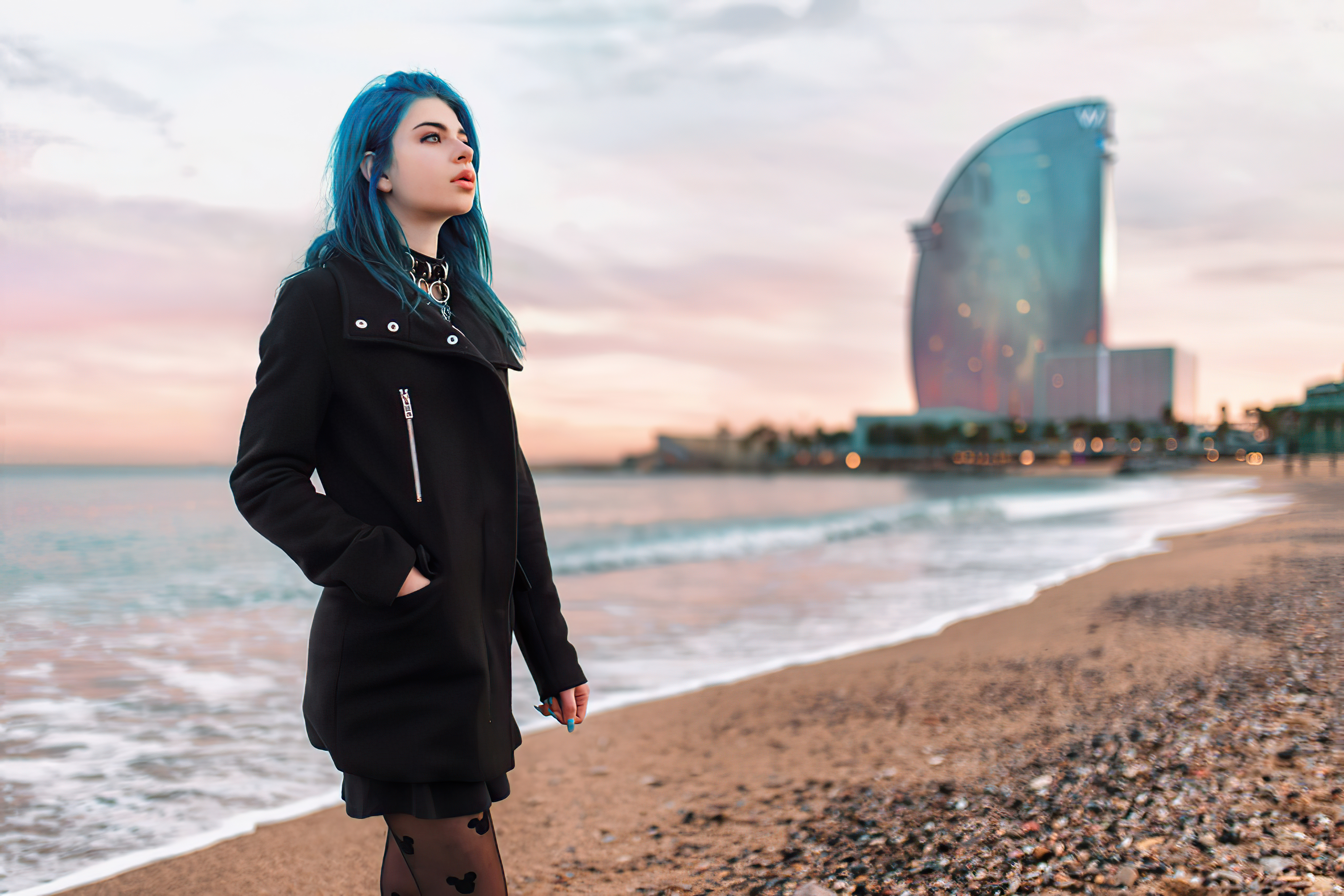 Girl with blue hair on a beach in front of a hotel HD Wallpaper