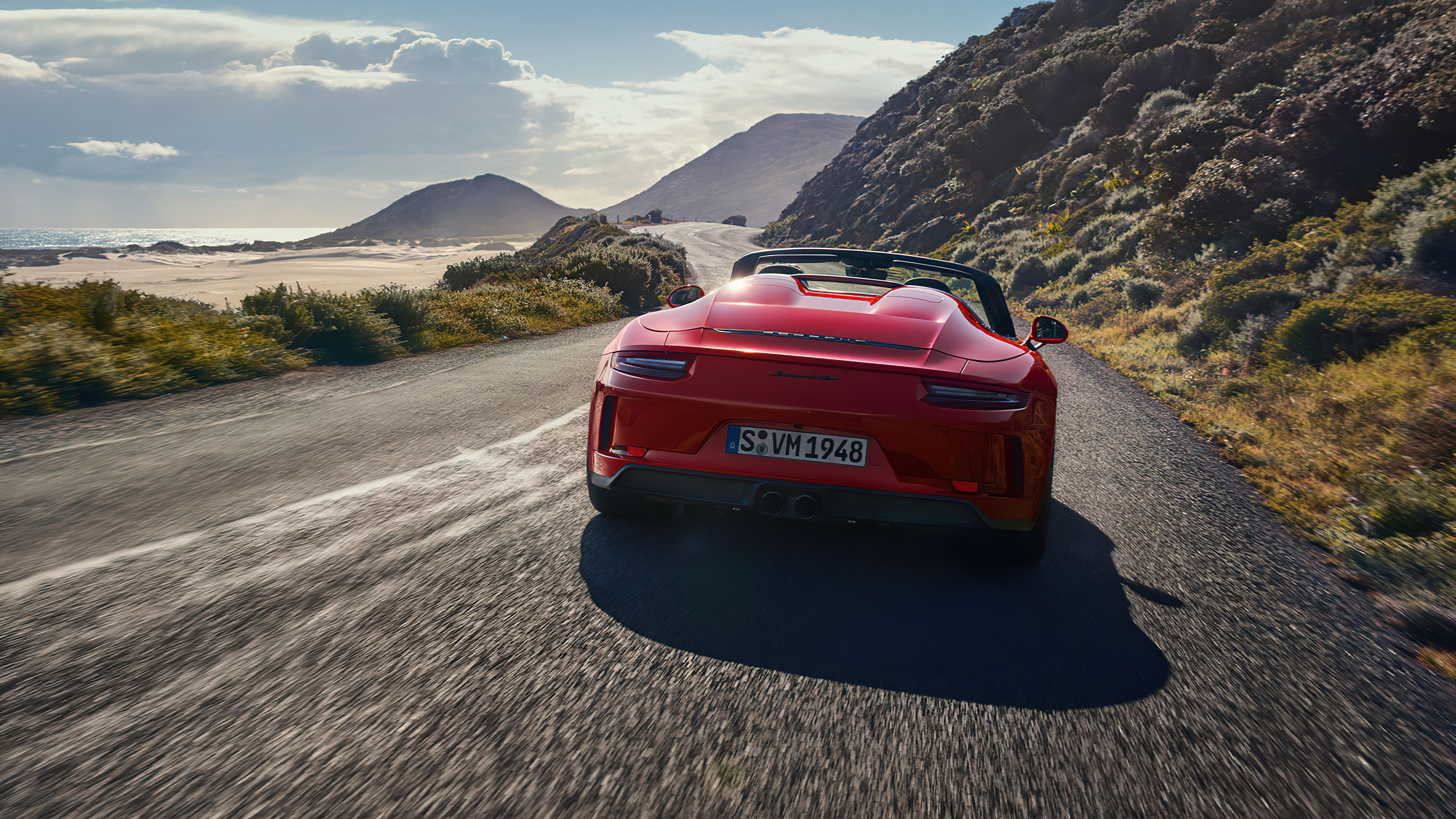 Red Porsche 911 Speedster driving on a coastal road HD Wallpaper