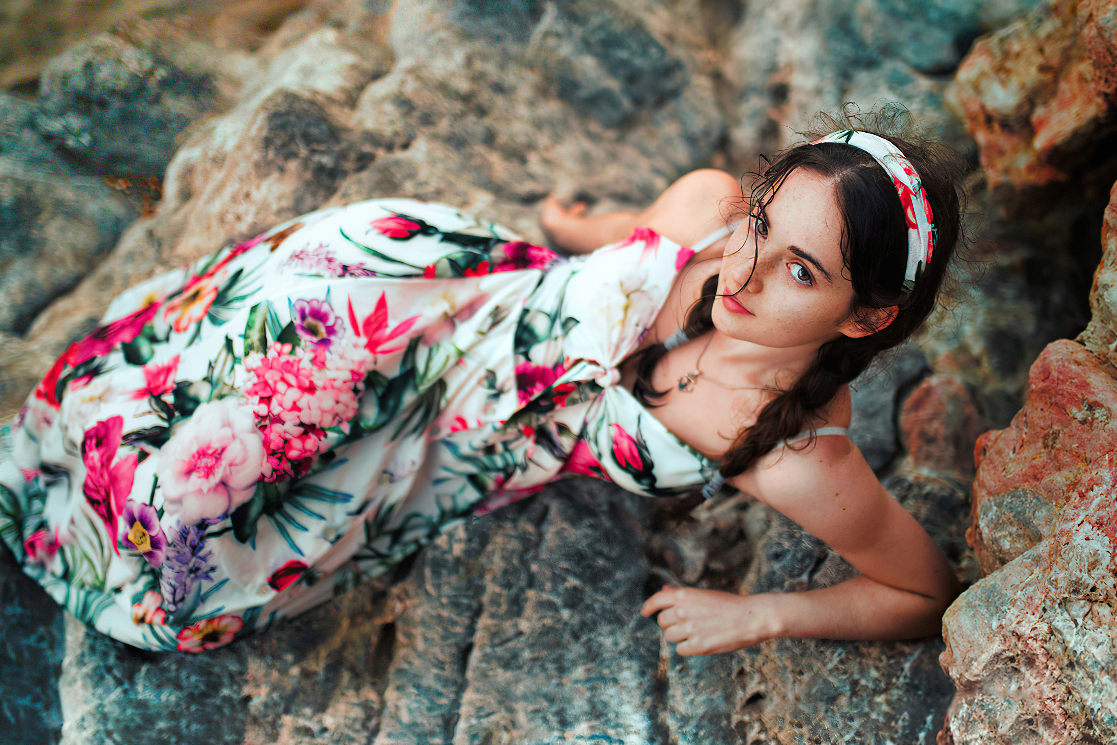 Girl in floral dress lying on rocks HD Wallpaper