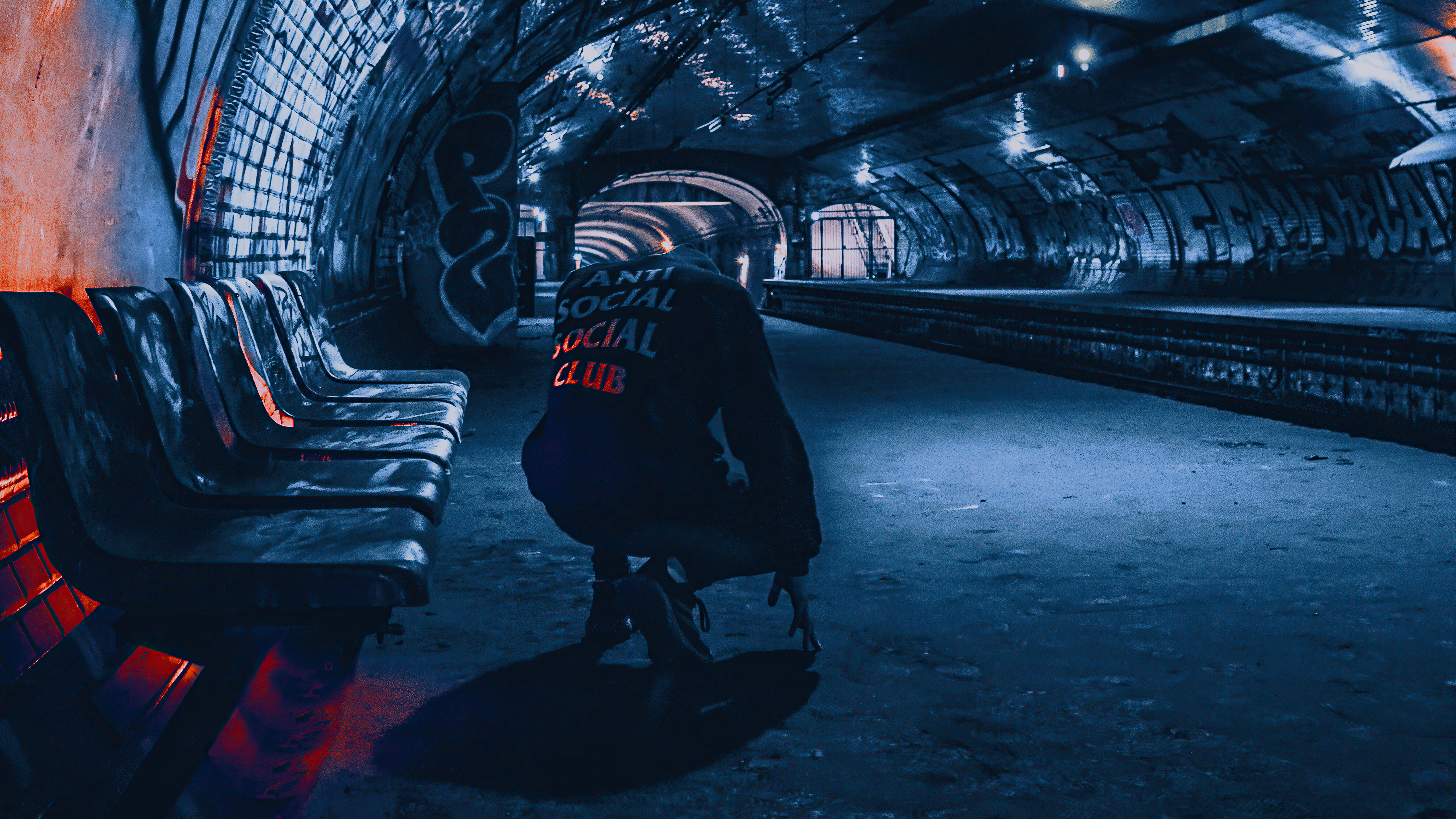 Person in hoodie in subway station HD Wallpaper