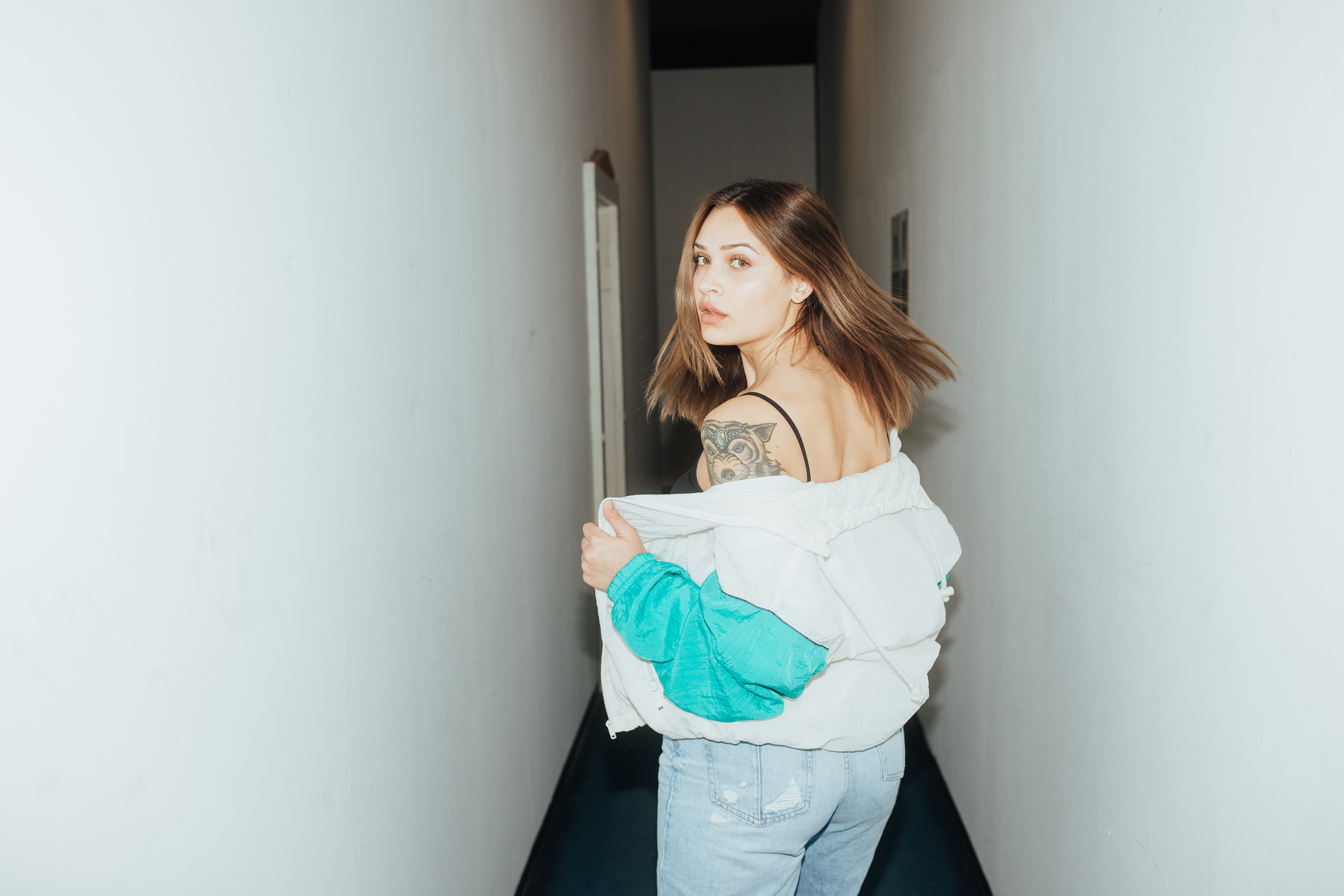 Woman with tattoo in a hallway HD Wallpaper