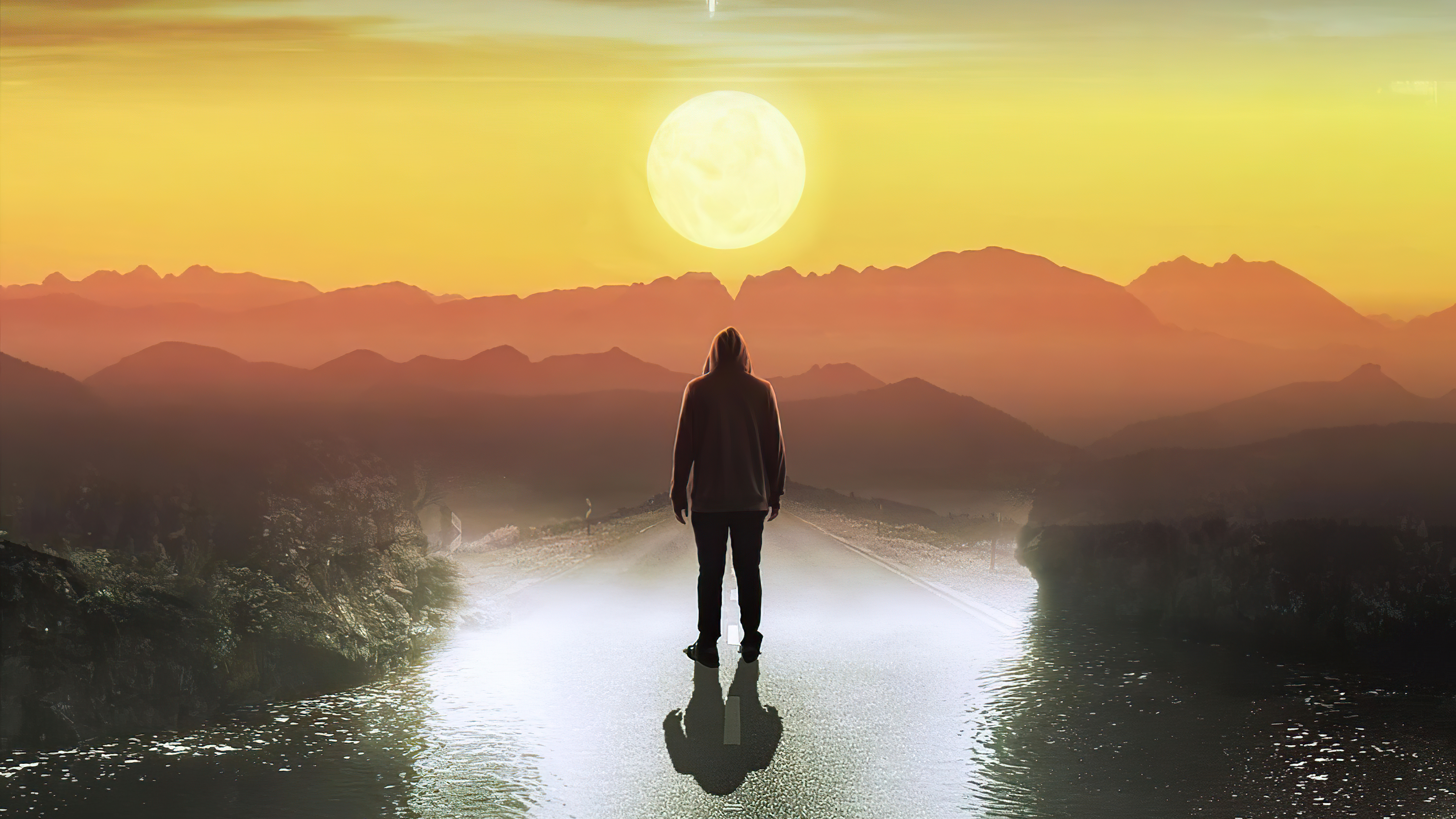 Person in hoodie standing on road at sunset HD Wallpaper