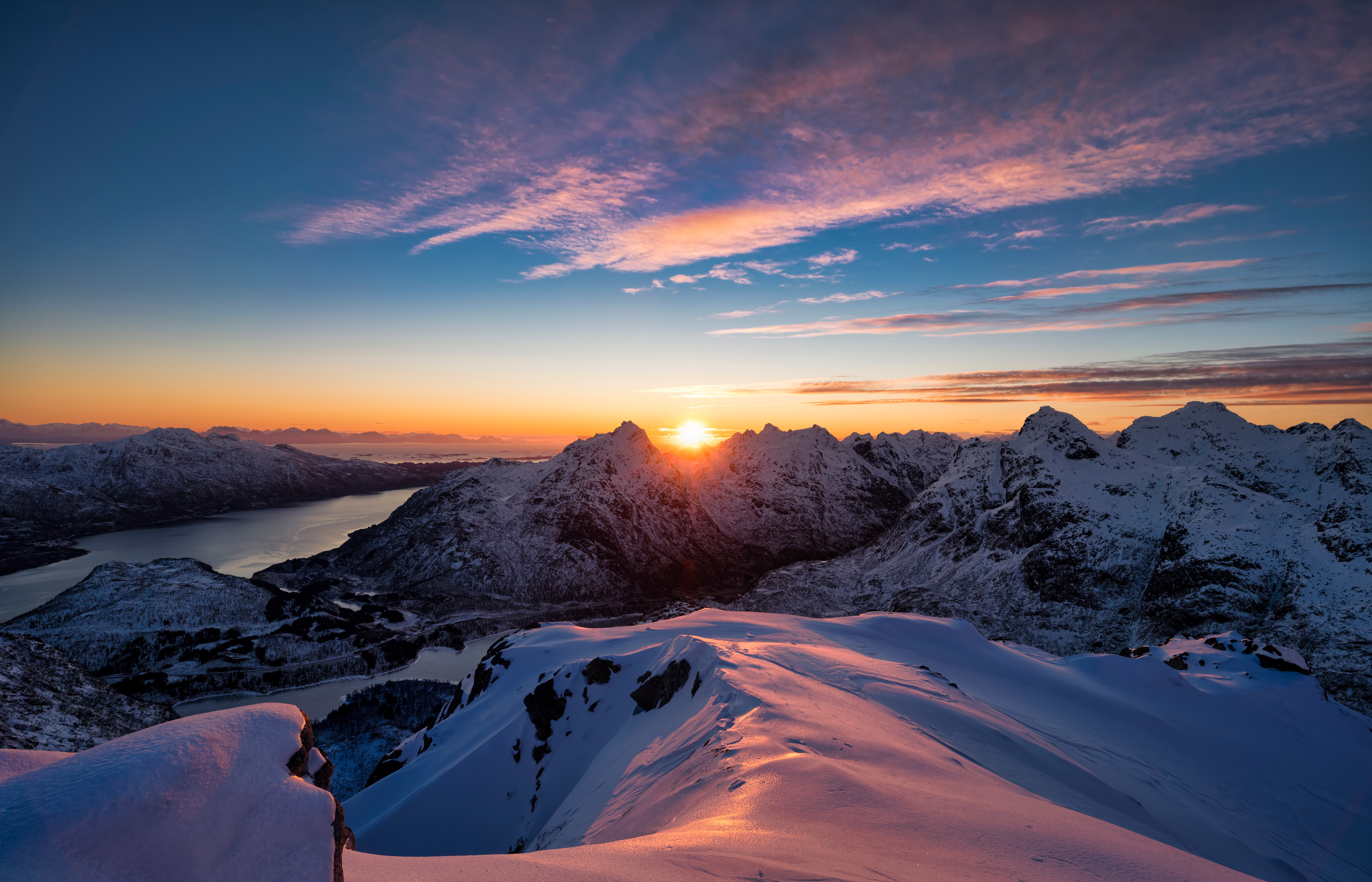 Snowy mountains at sunrise with a lake HD Wallpaper