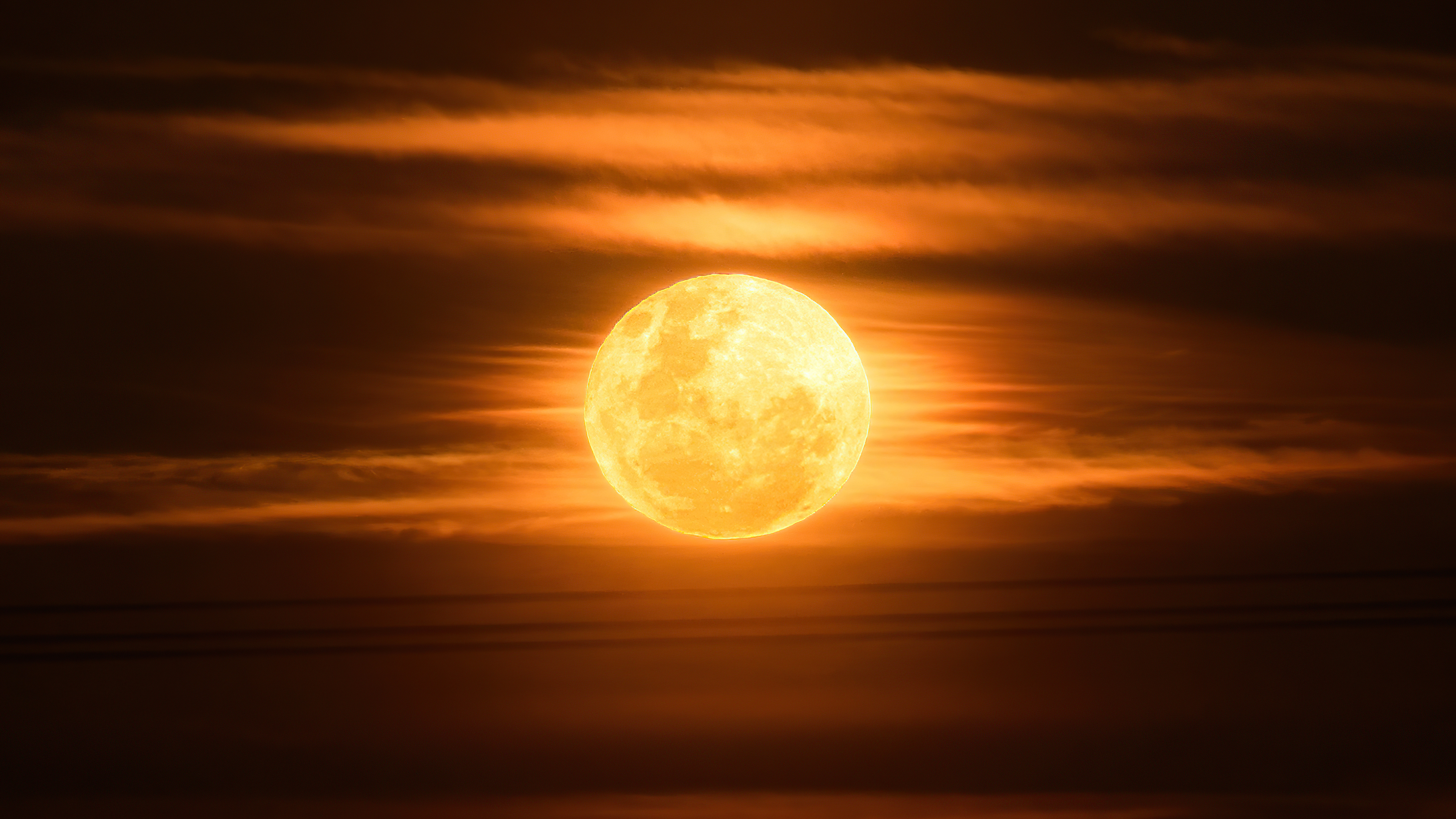 Full moon behind orange clouds 4K HD Wallpaper