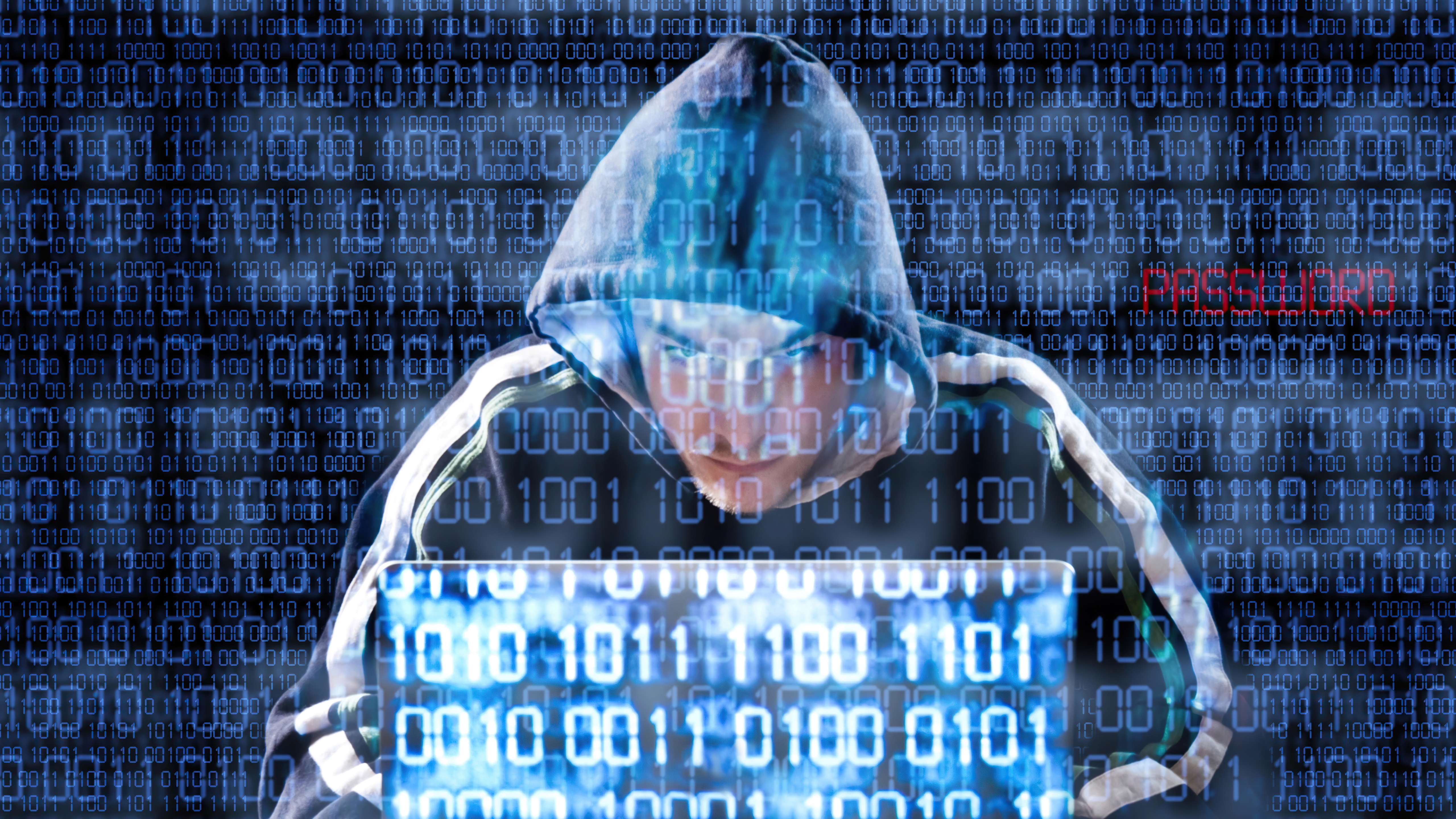 Hacker in a hoodie using a laptop with binary code HD Wallpaper