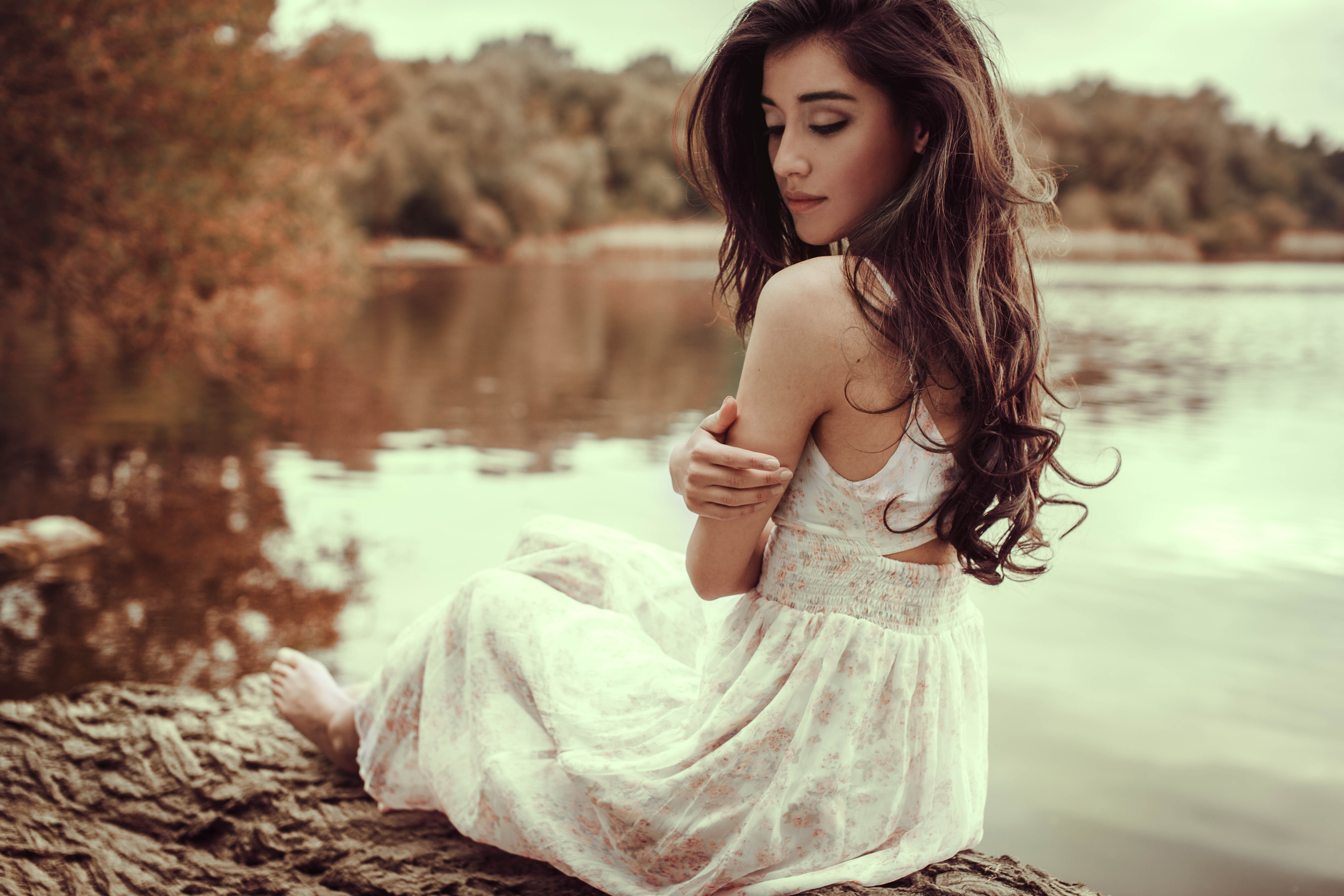 Woman in white dress sitting by a lake HD Wallpaper