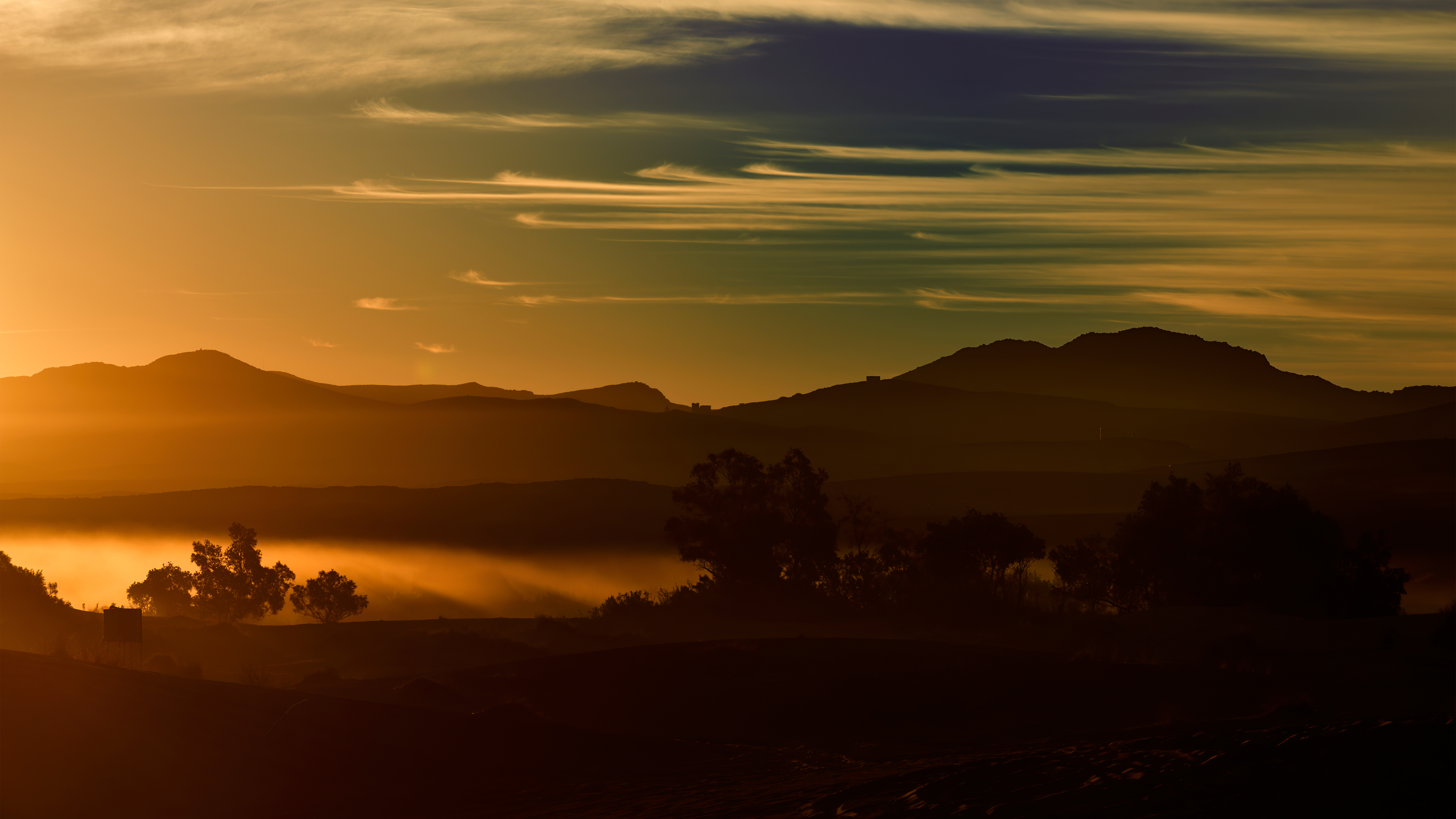 Misty mountains at sunrise with wispy clouds HD Wallpaper