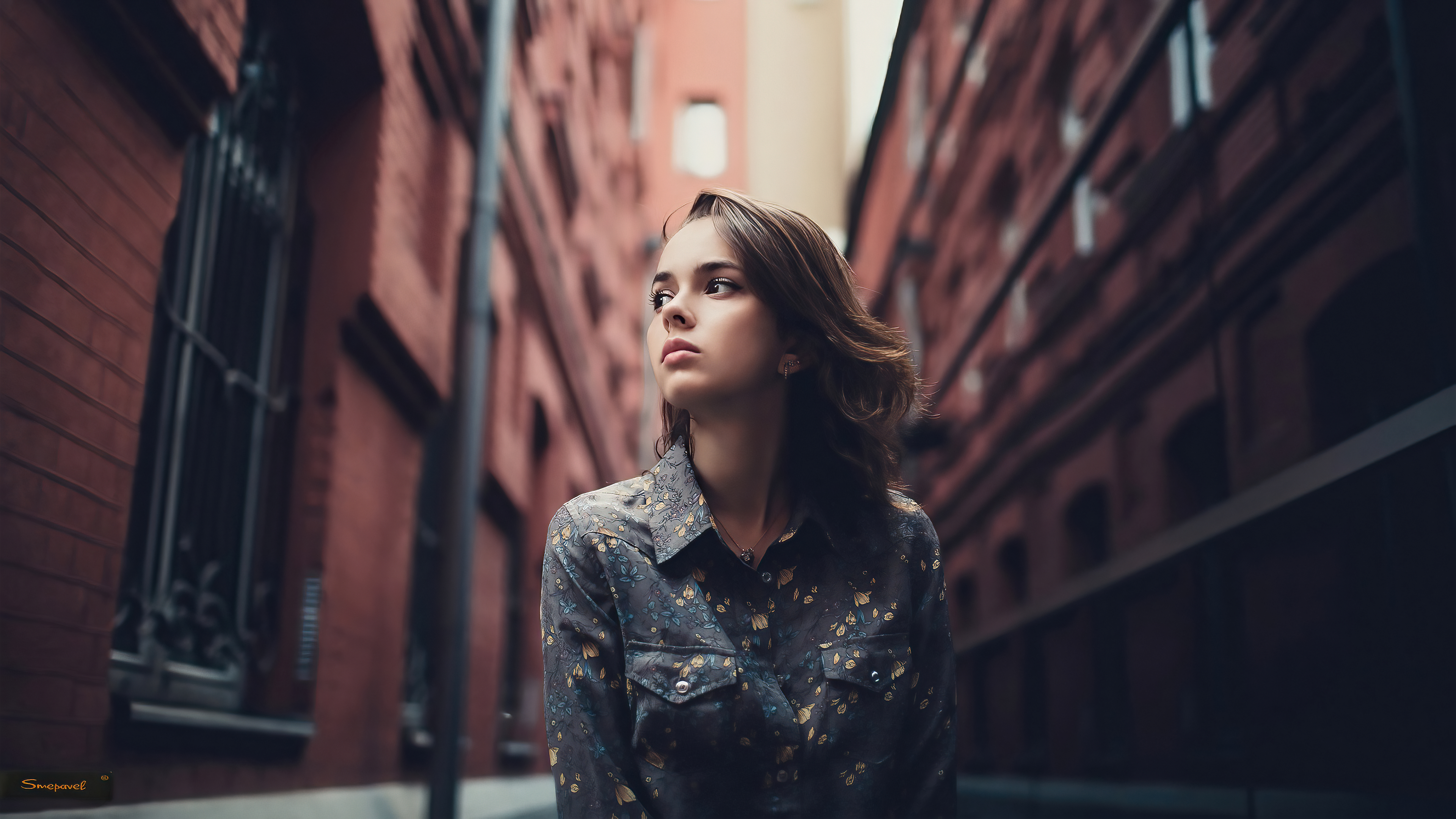 Brunette girl in a patterned shirt standing in an alley HD Wallpaper