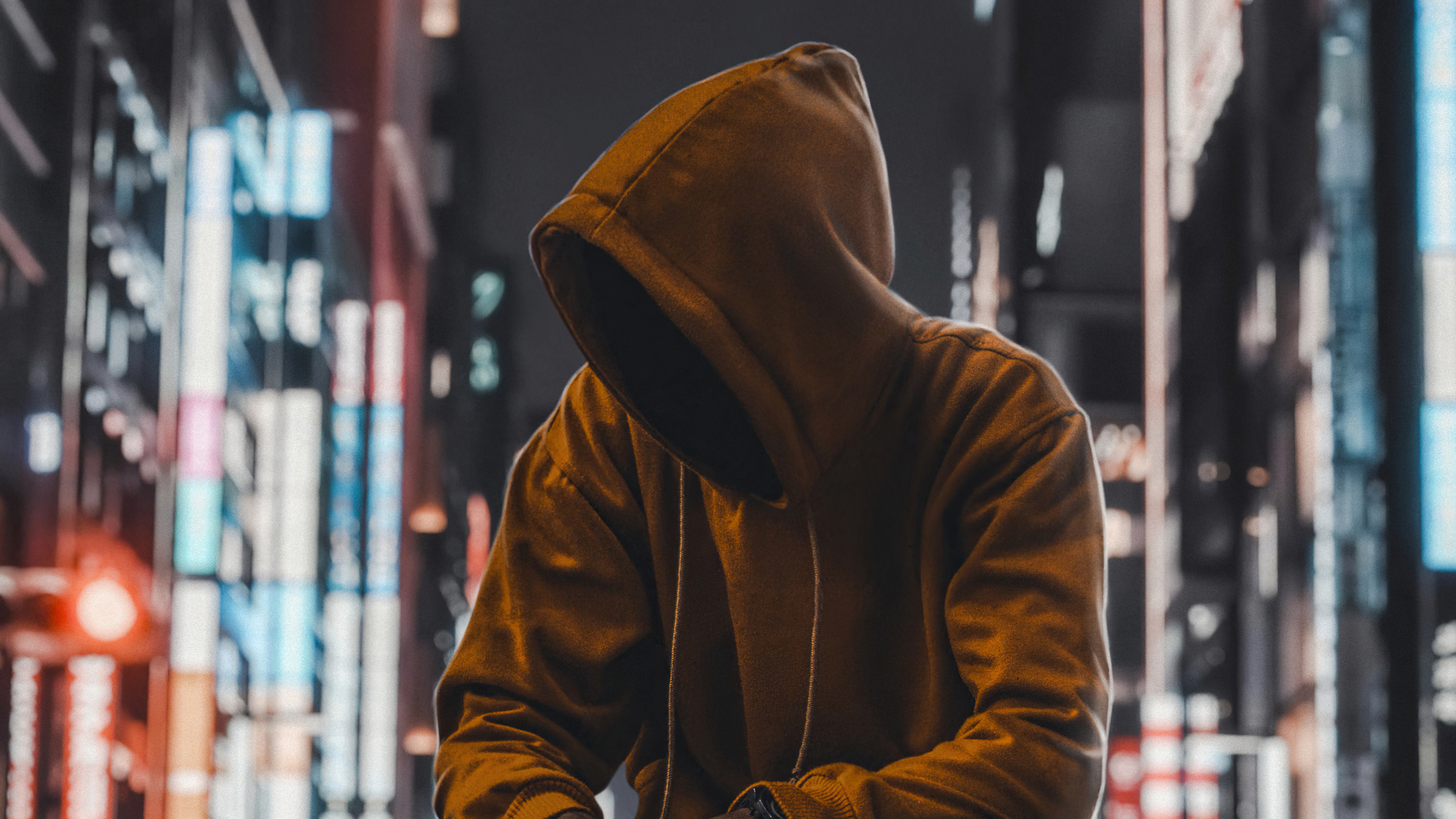 Person in hoodie in city at night HD Wallpaper