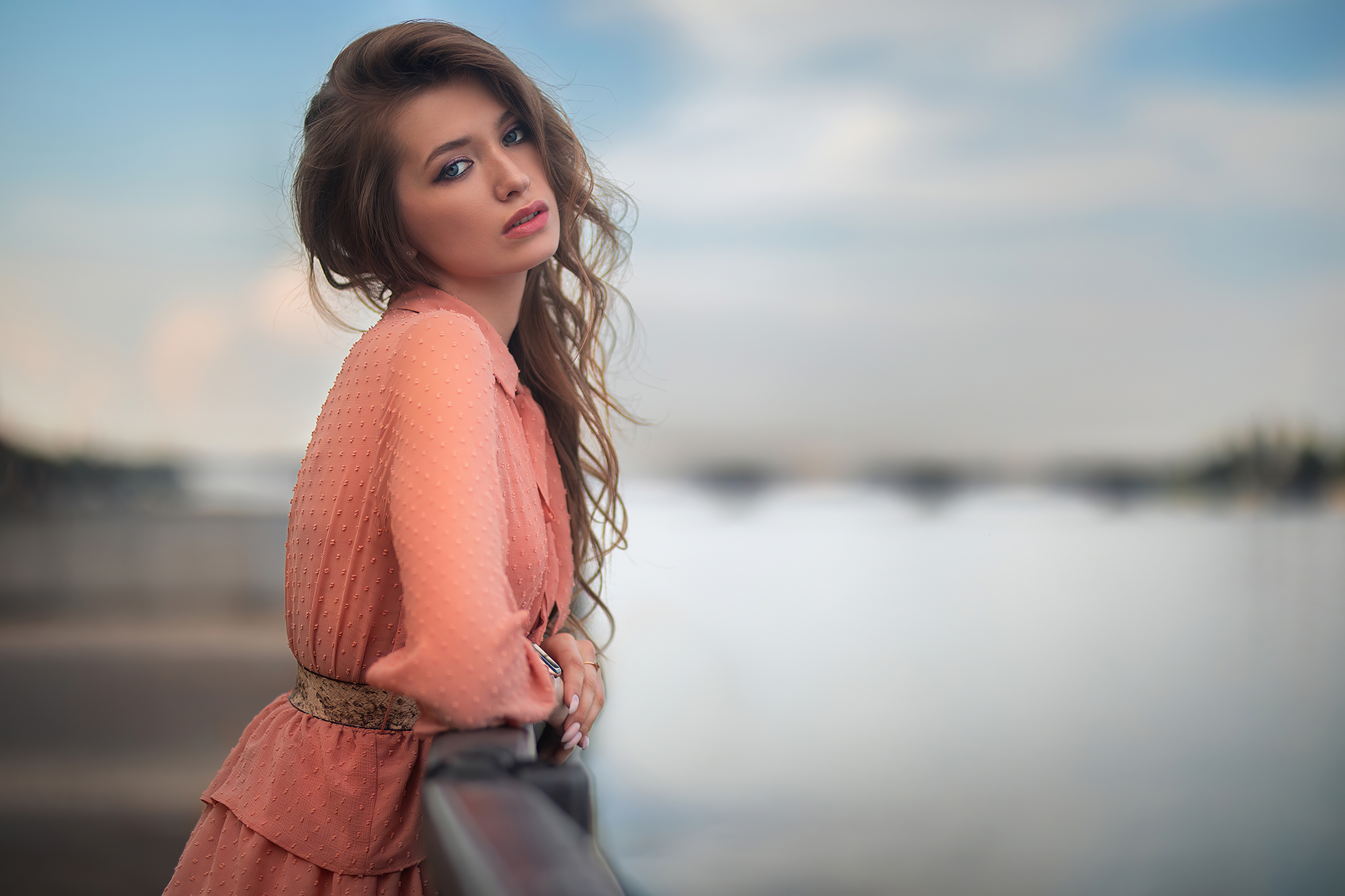 Brunette model in a peach dress by the water HD Wallpaper